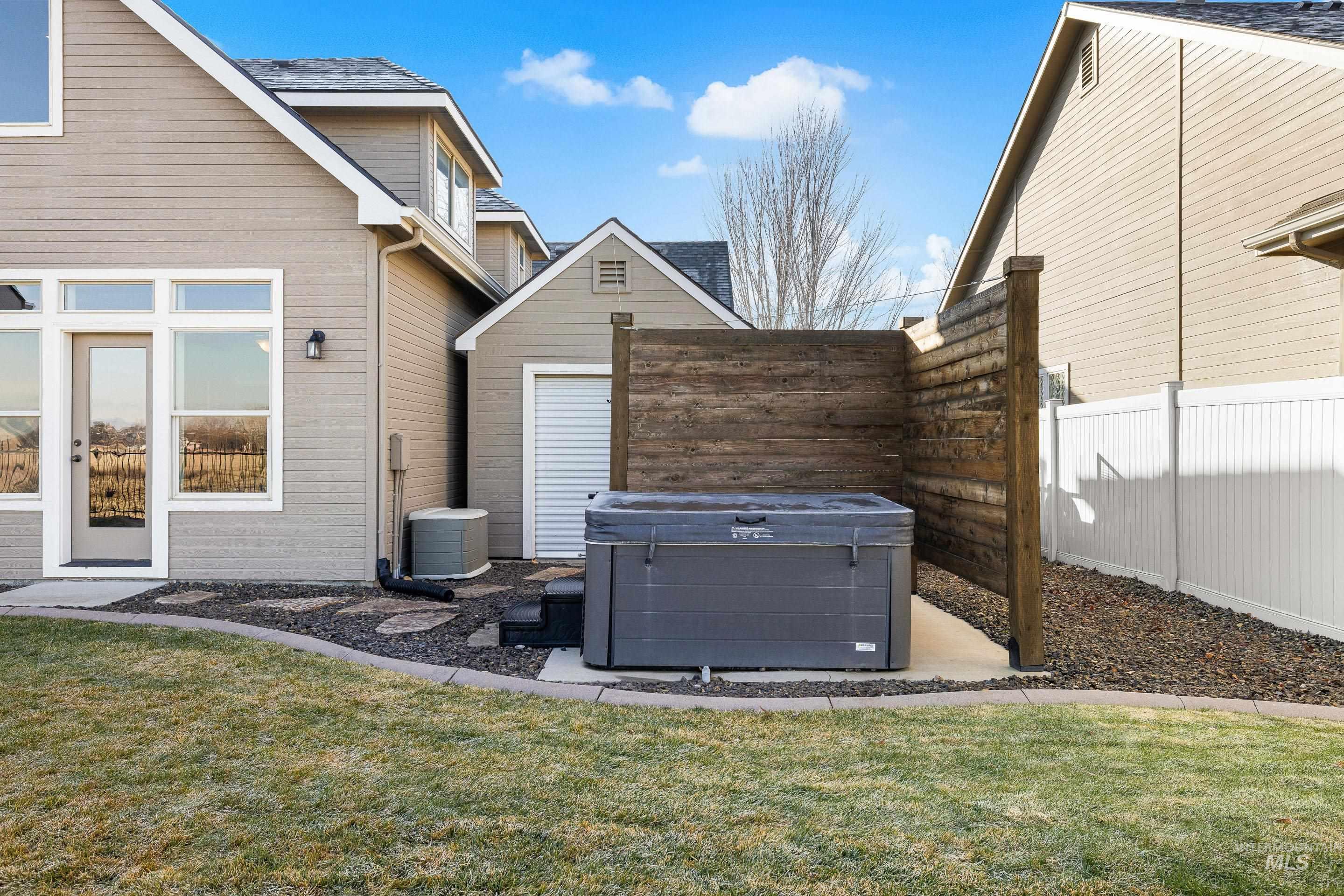 Exterior view of a downspout, a hot tub, and gutters