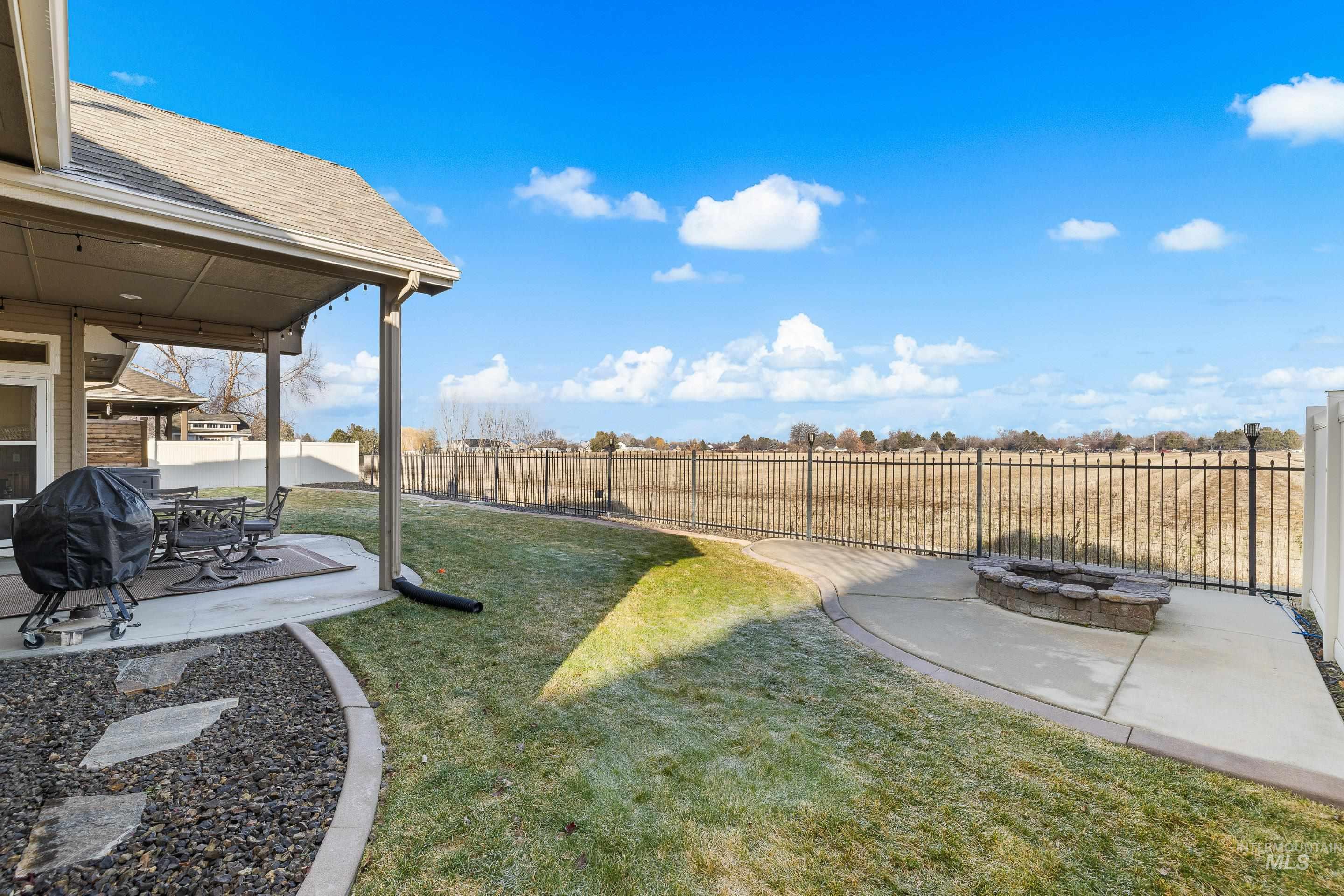 Fenced backyard with a patio and an outdoor fire pit