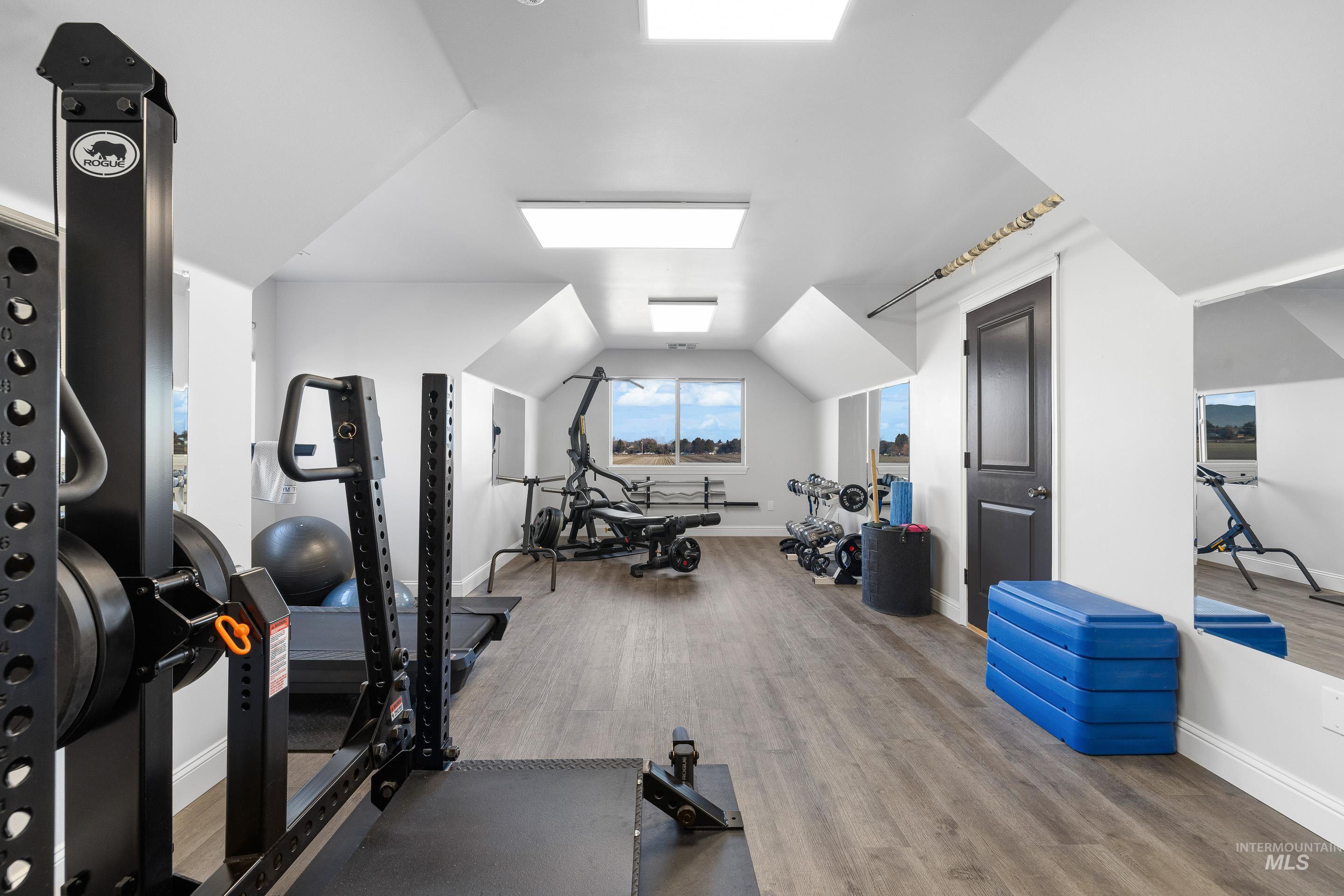 Workout area with lofted ceiling
