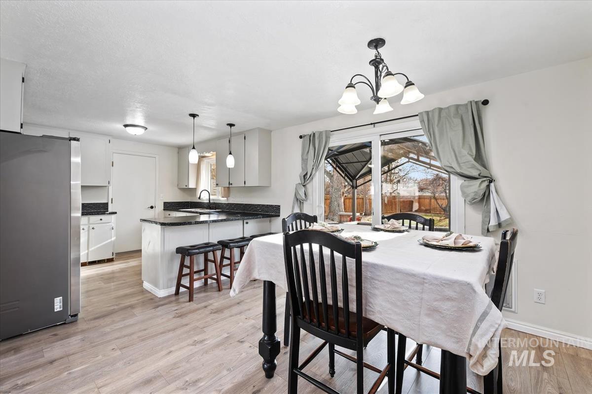 Dining room with a chandelier and light wood-type flooring