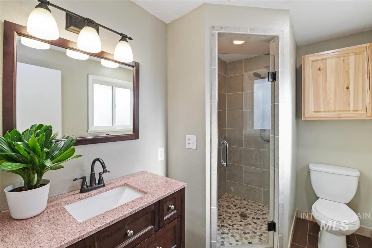 Bathroom featuring vanity and a stall shower