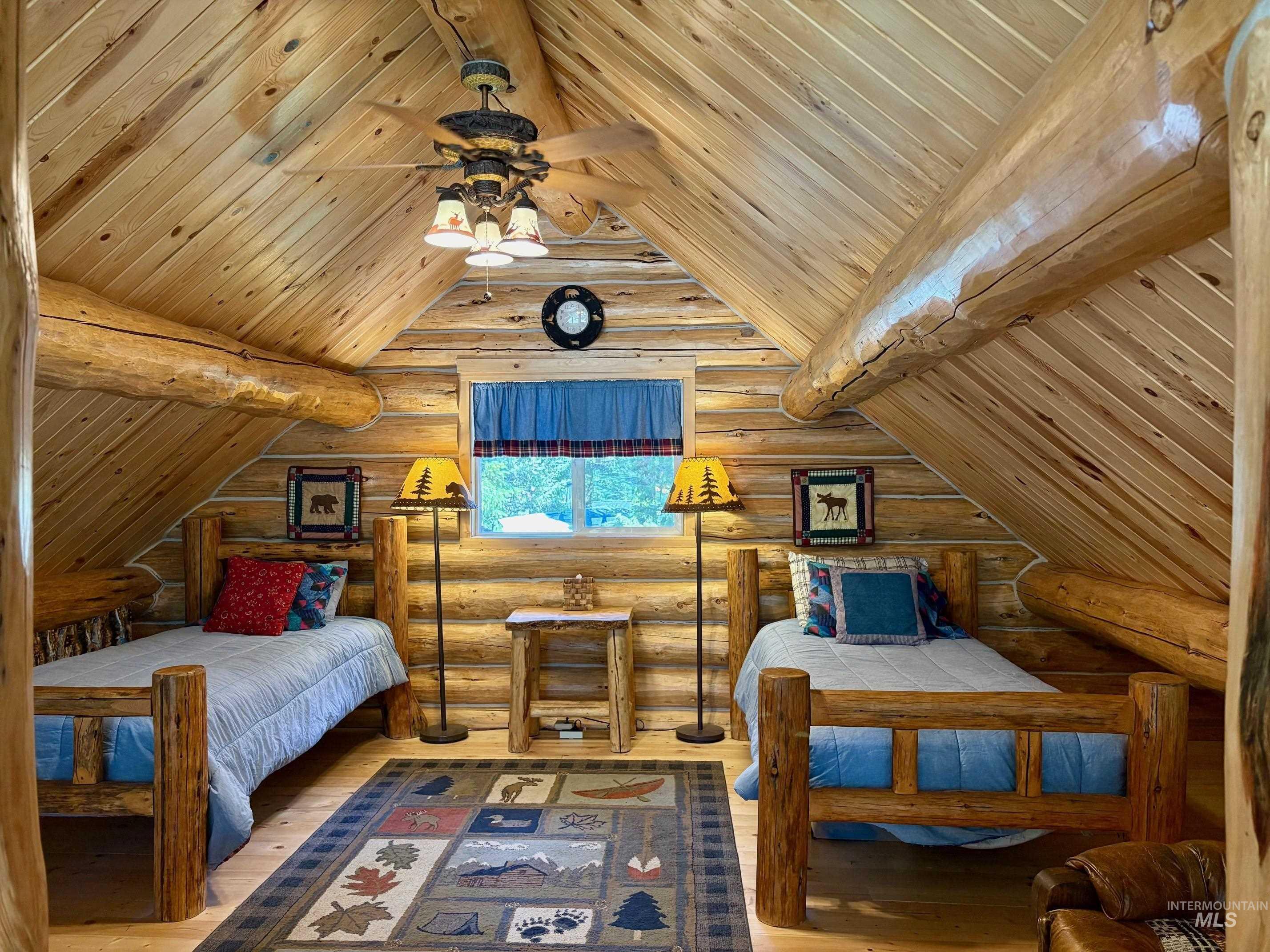 Bedroom with hardwood / wood-style floors, a ceiling fan, log walls, and wooden ceiling