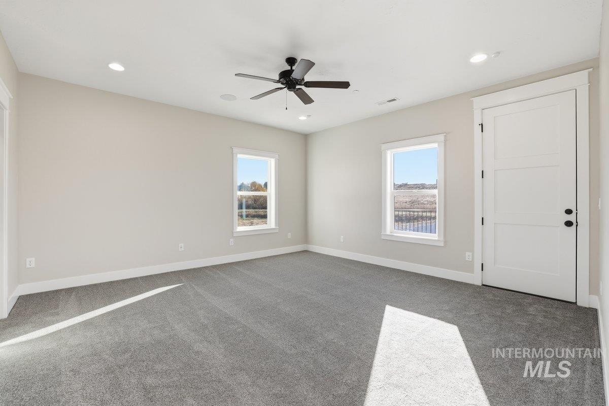 Bedroom with carpet floors, recessed lighting, and a ceiling fan and walk-in closet