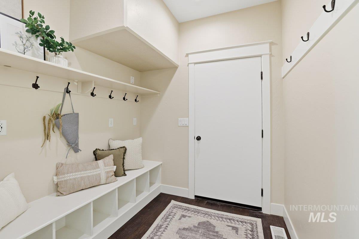 Mudroom featuring baseboards and dark wood-style flooring