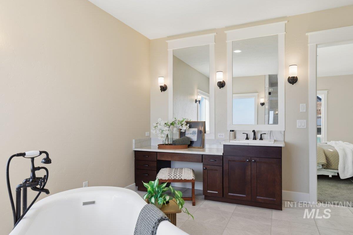 Ensuite bathroom with vanity, and soaking tub