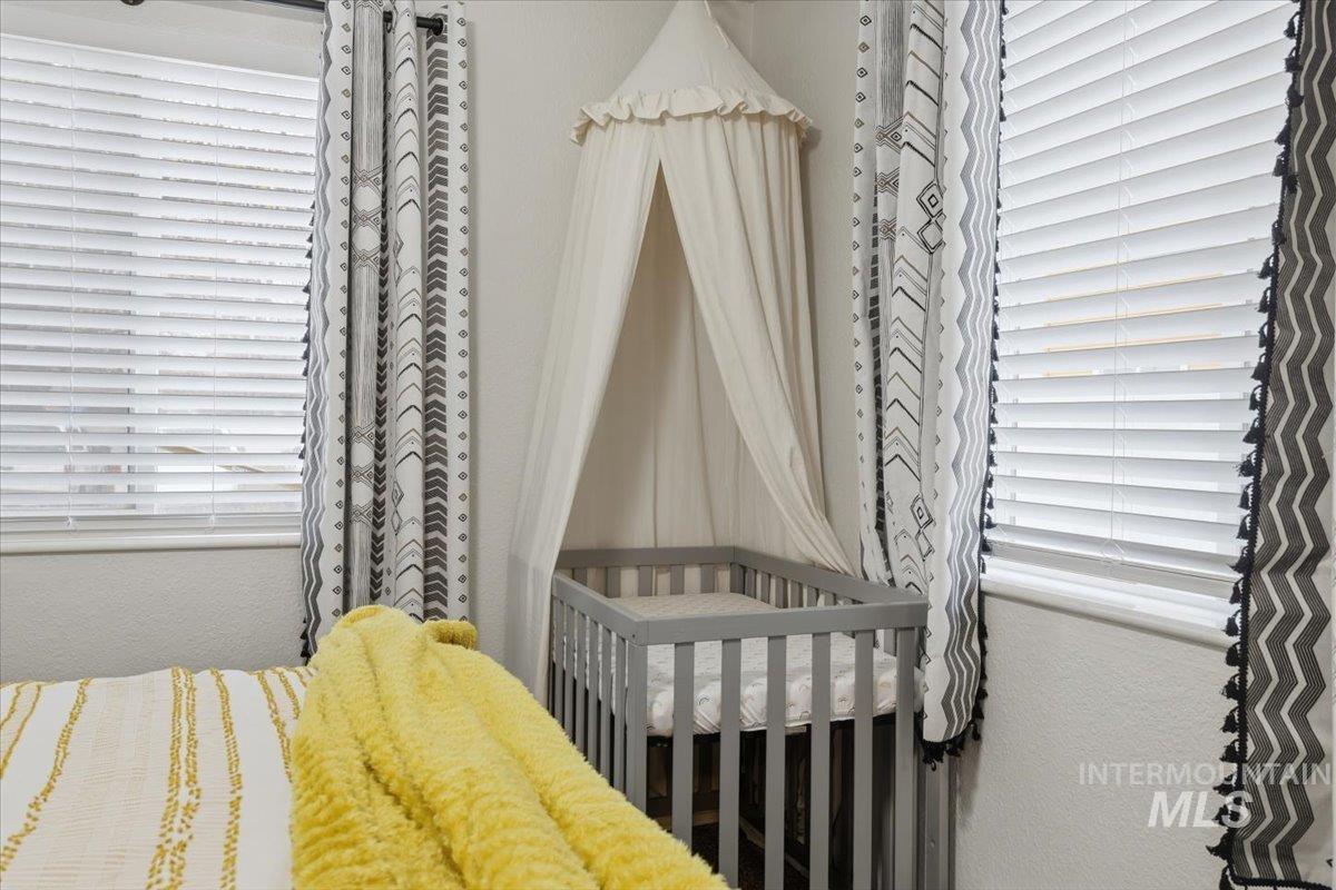 Bedroom with a textured wall and a crib