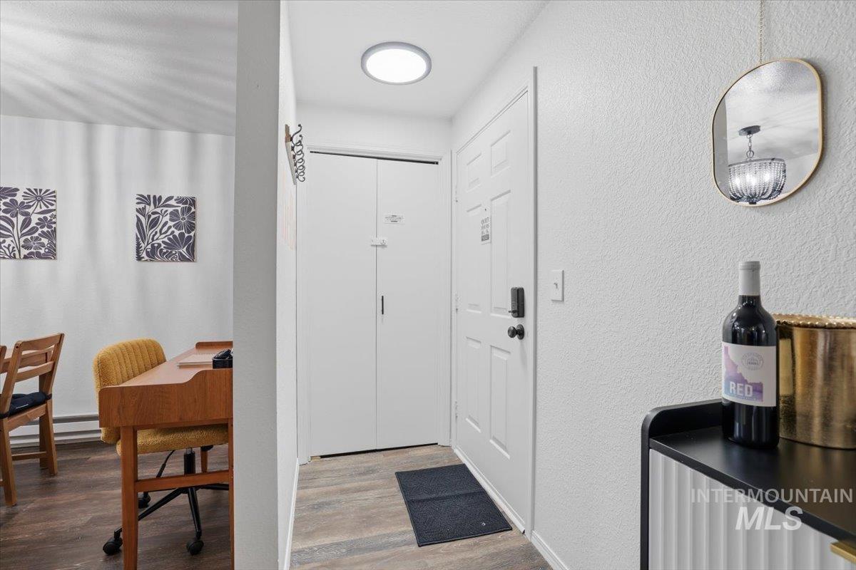 Entryway with a textured wall and wood finished floors