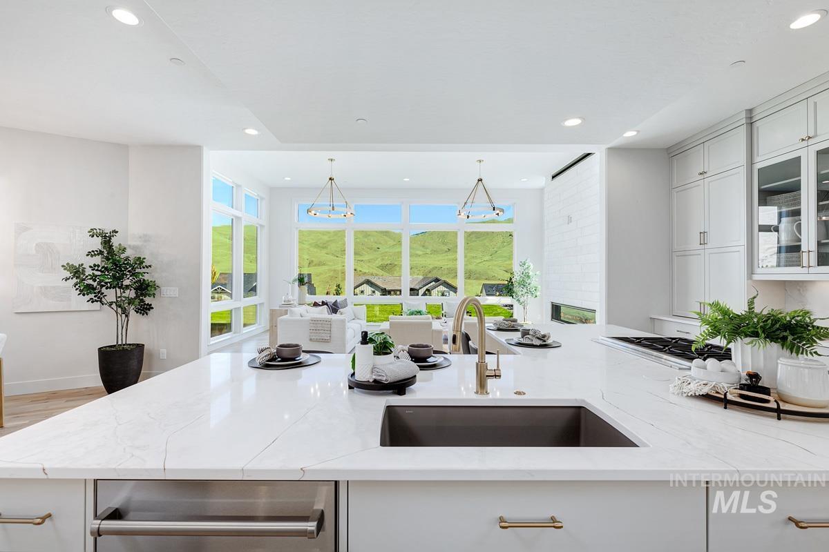 Kitchen island with an undermount sink, a gooseneck faucet, and integrated dishwasher