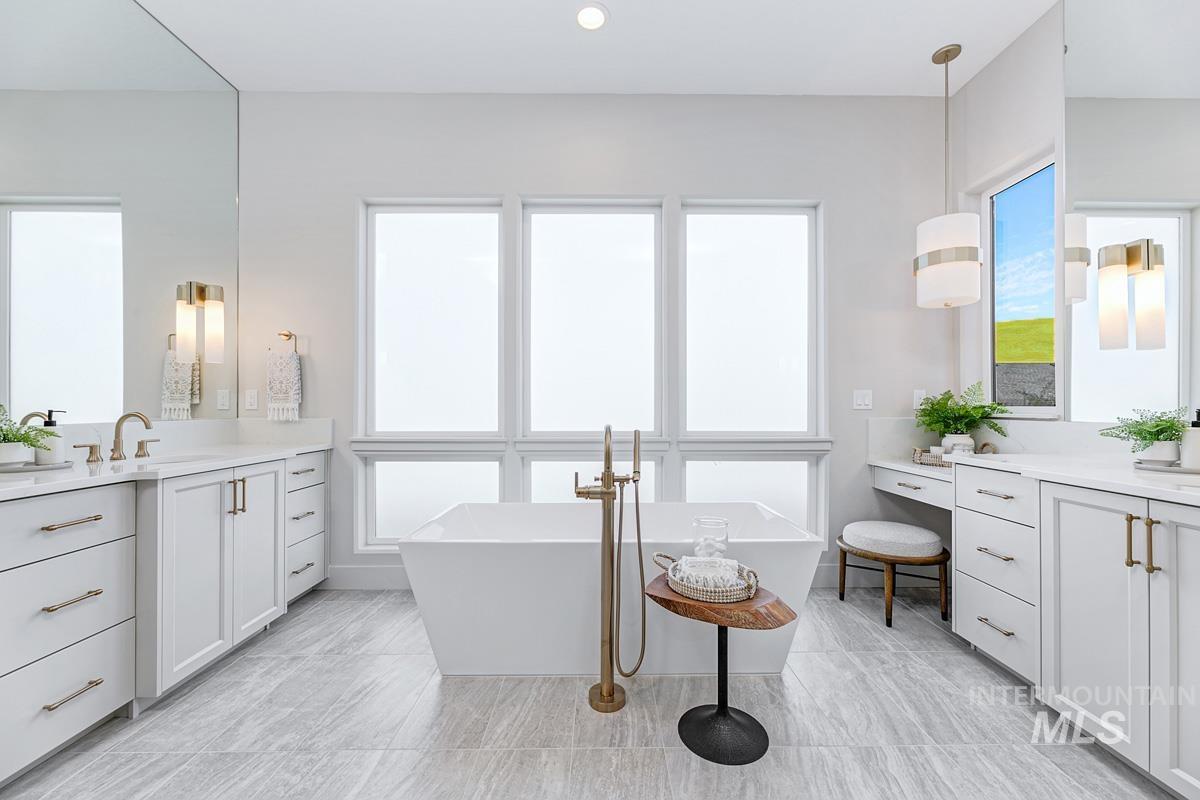 Freestanding soaking tub with a floor-mounted brass faucet
