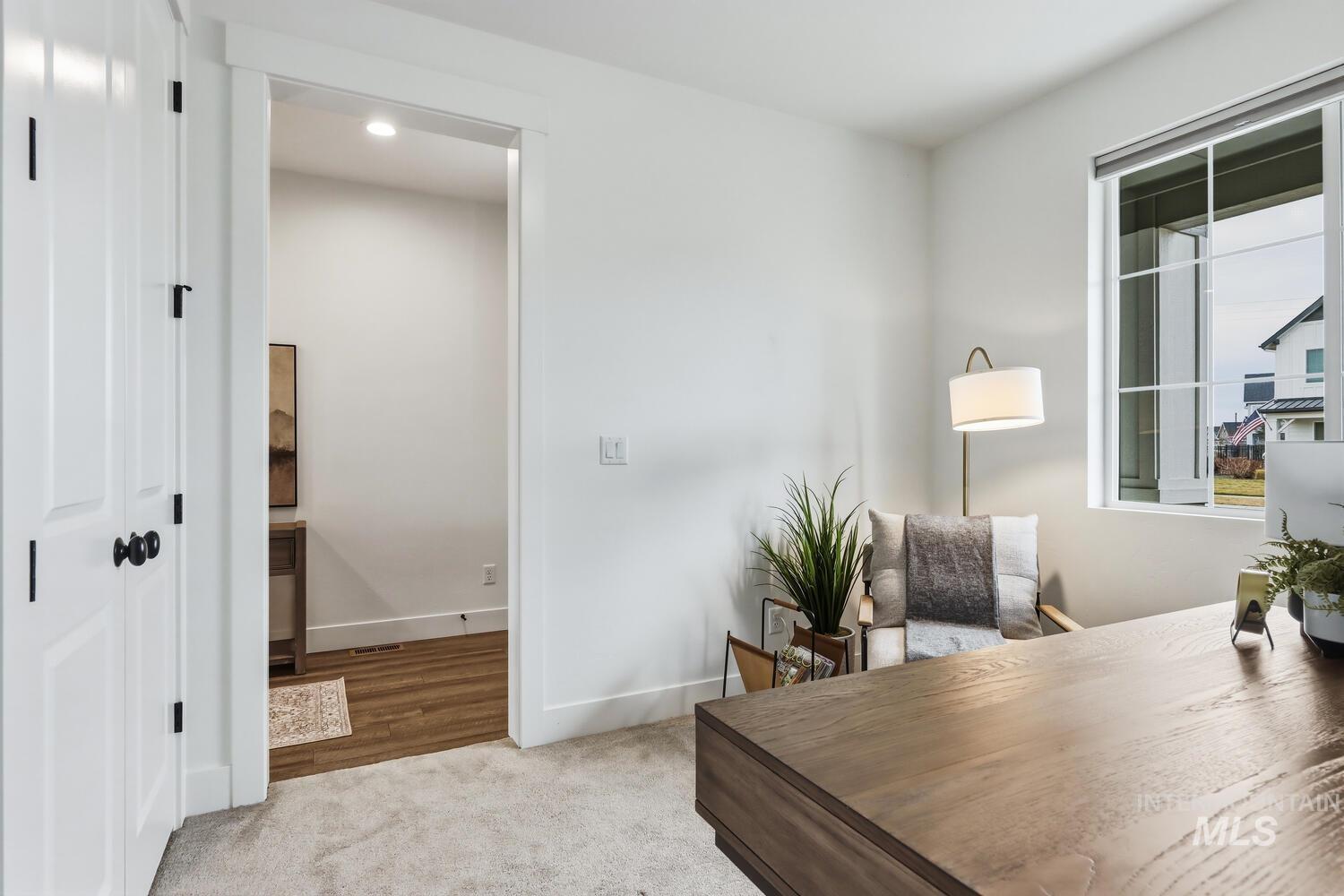 Office featuring light carpet and baseboards