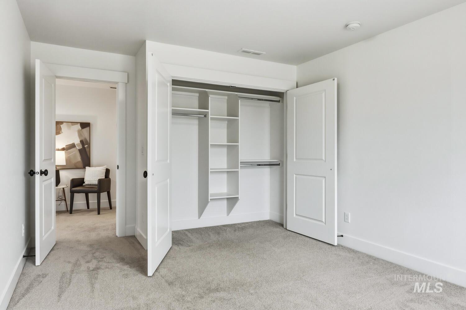 Bedroom featuring light carpet and a closet