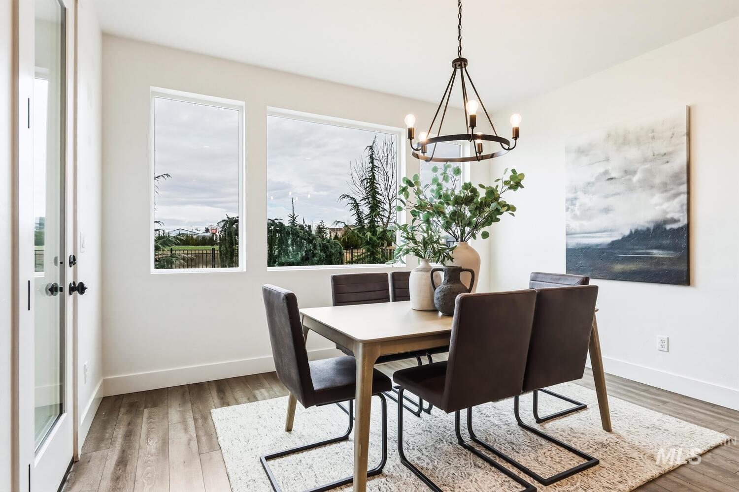 Dining space with a chandelier and light wood-style floors