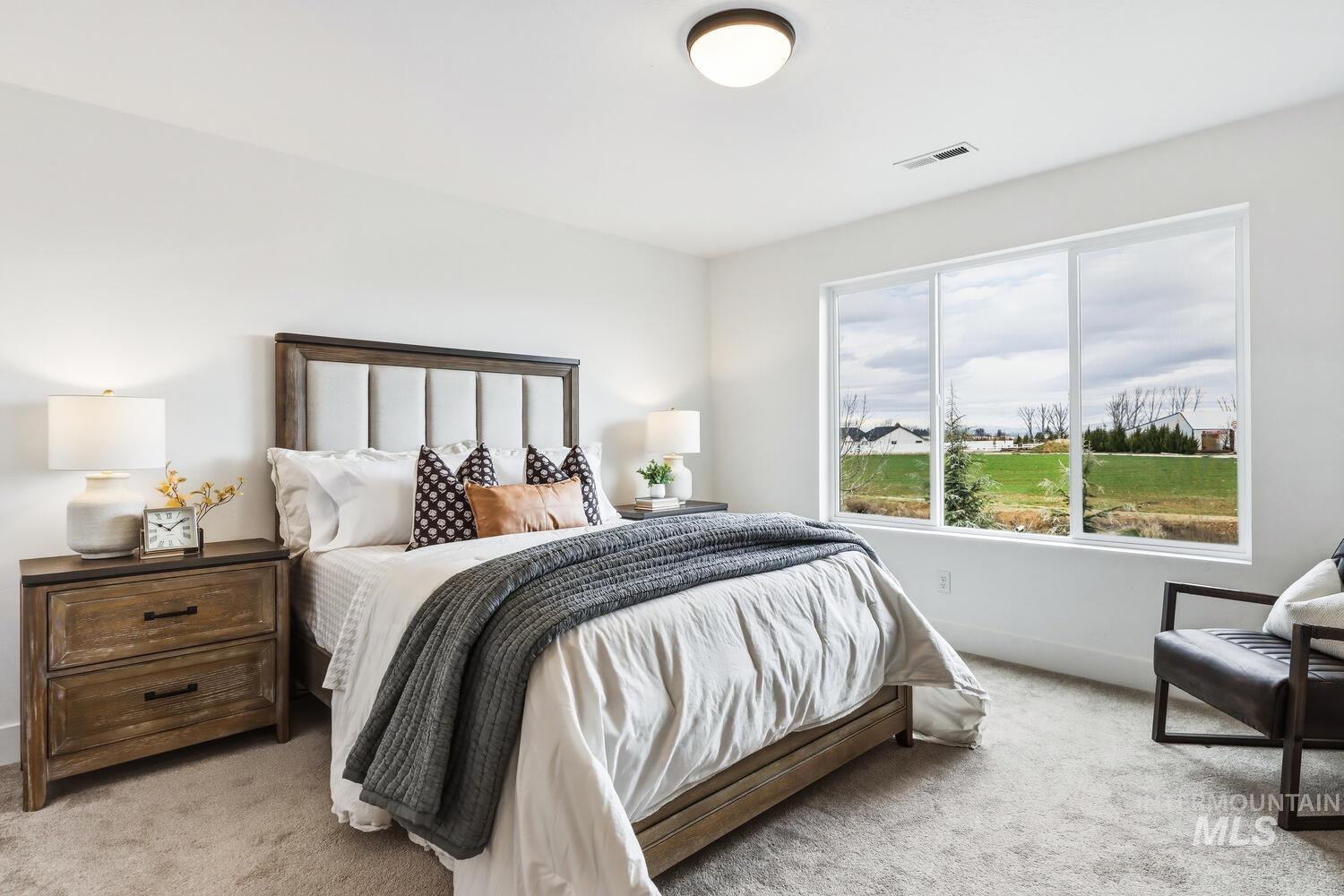 Bedroom featuring light carpet