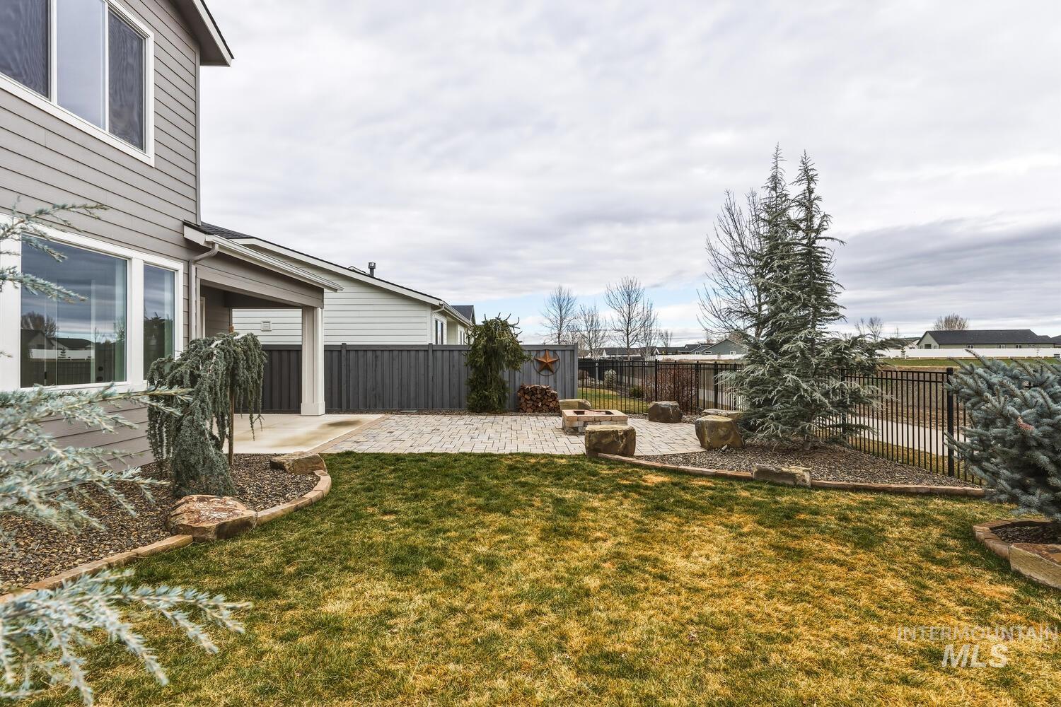 Fenced backyard with a patio
