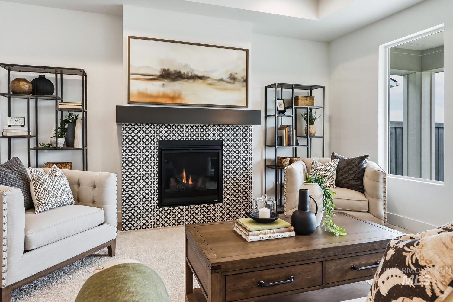 Living room with a tiled fireplace and carpet flooring