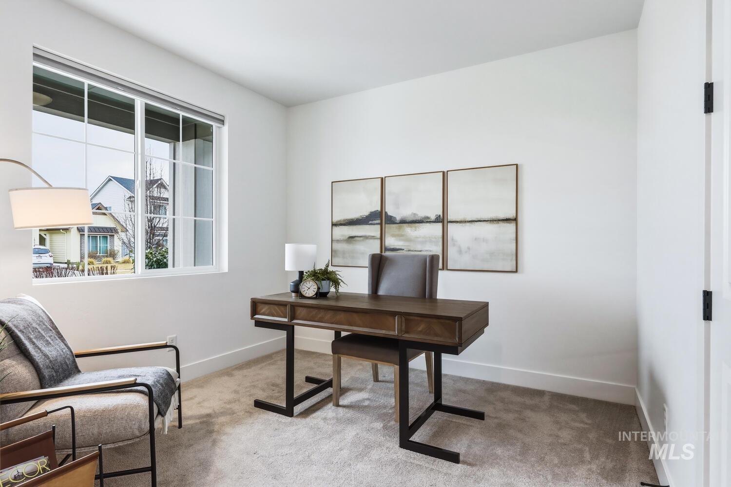 Office area with light colored carpet and baseboards