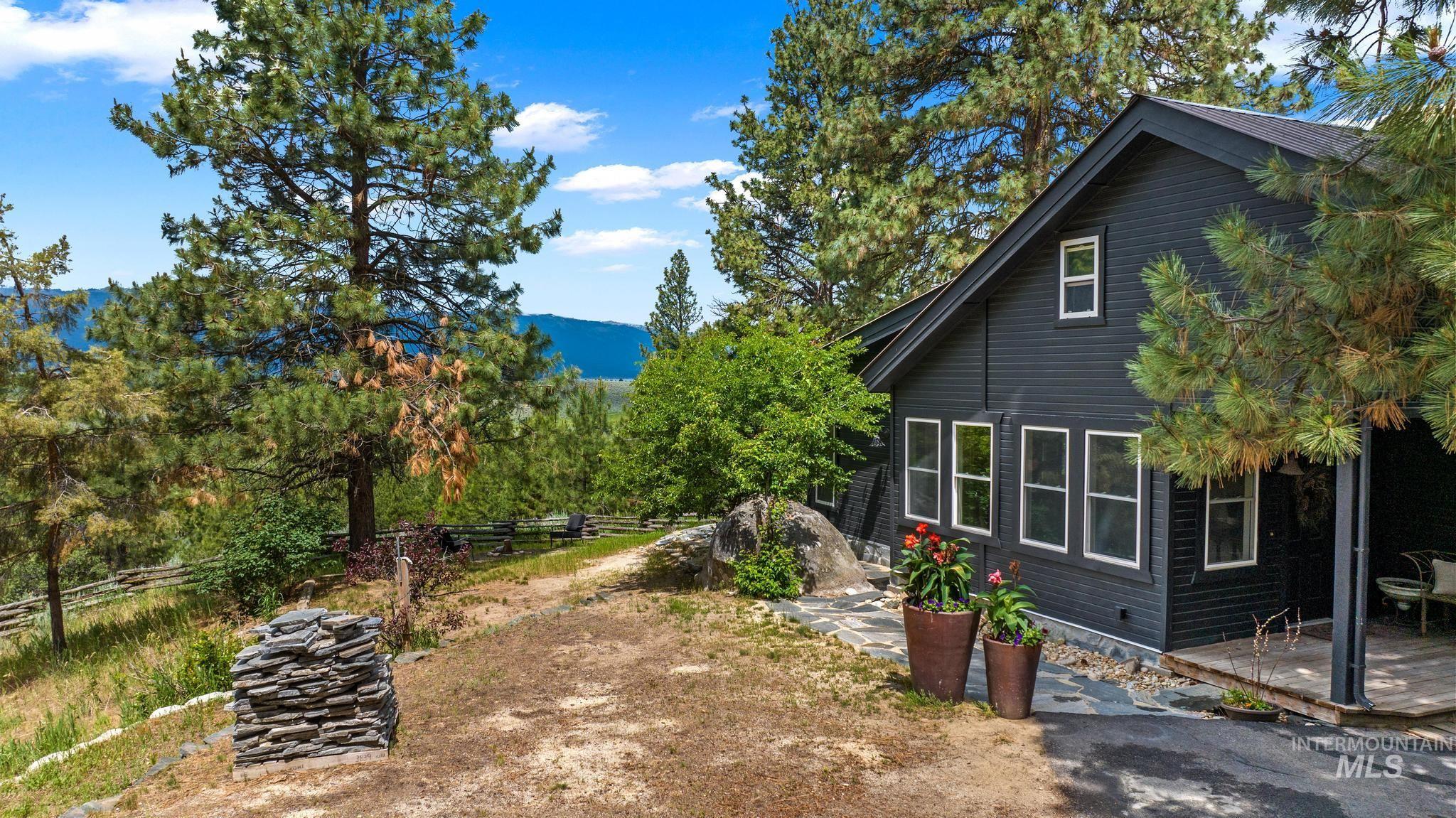 View of side of property with a patio area and a mountain view