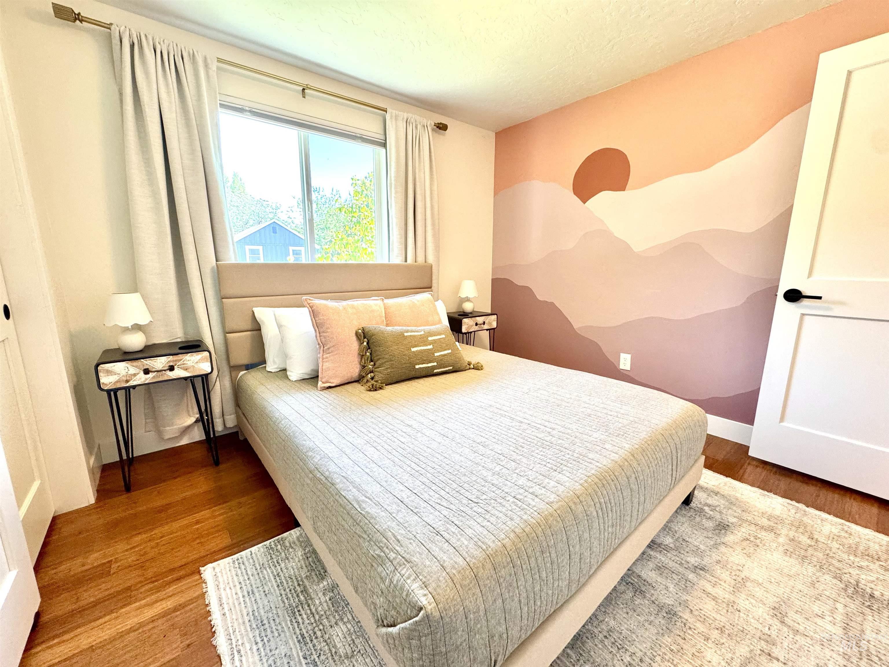 Bedroom featuring wood finished floors and a textured ceiling