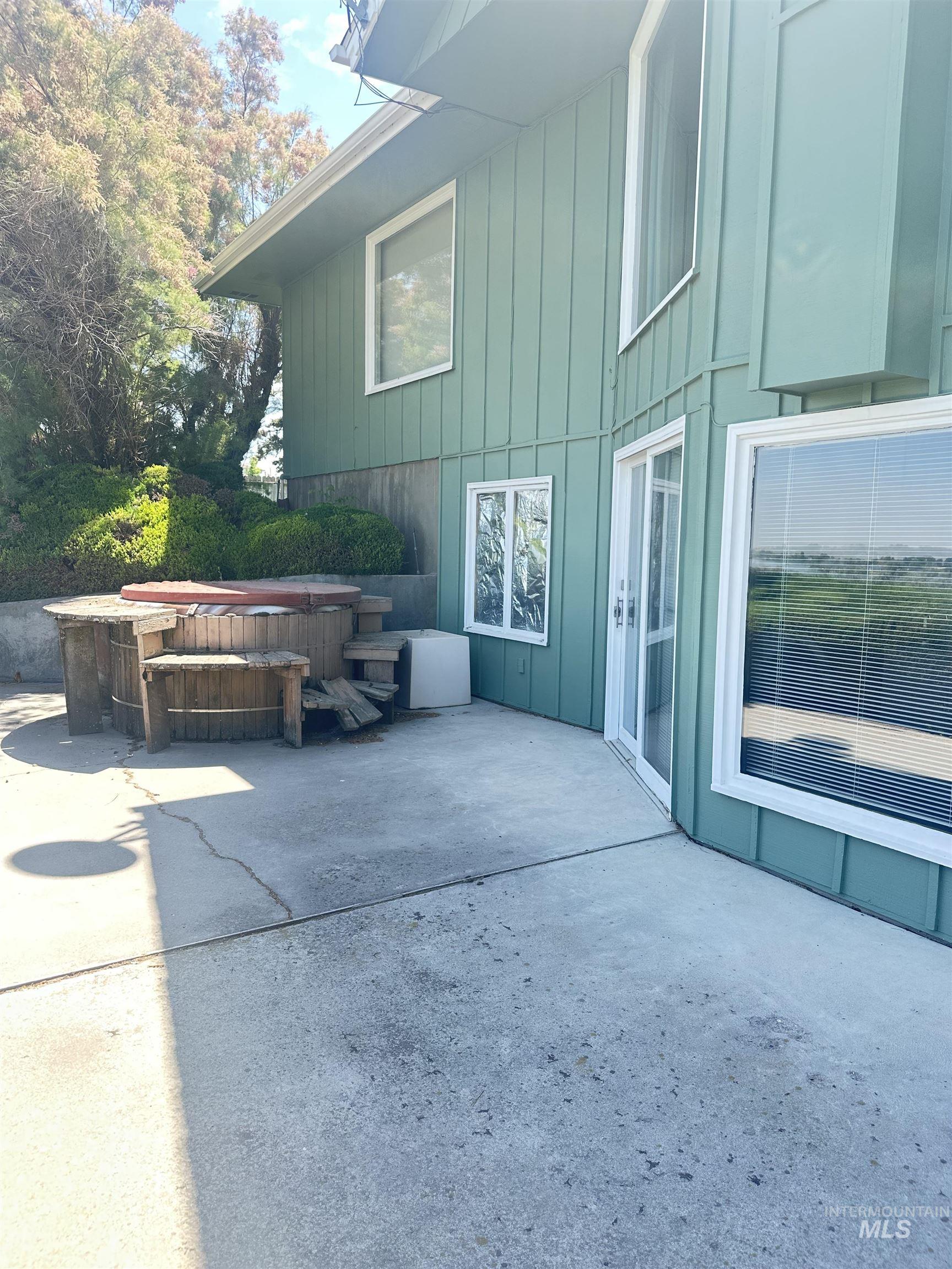 View of patio with a hot tub