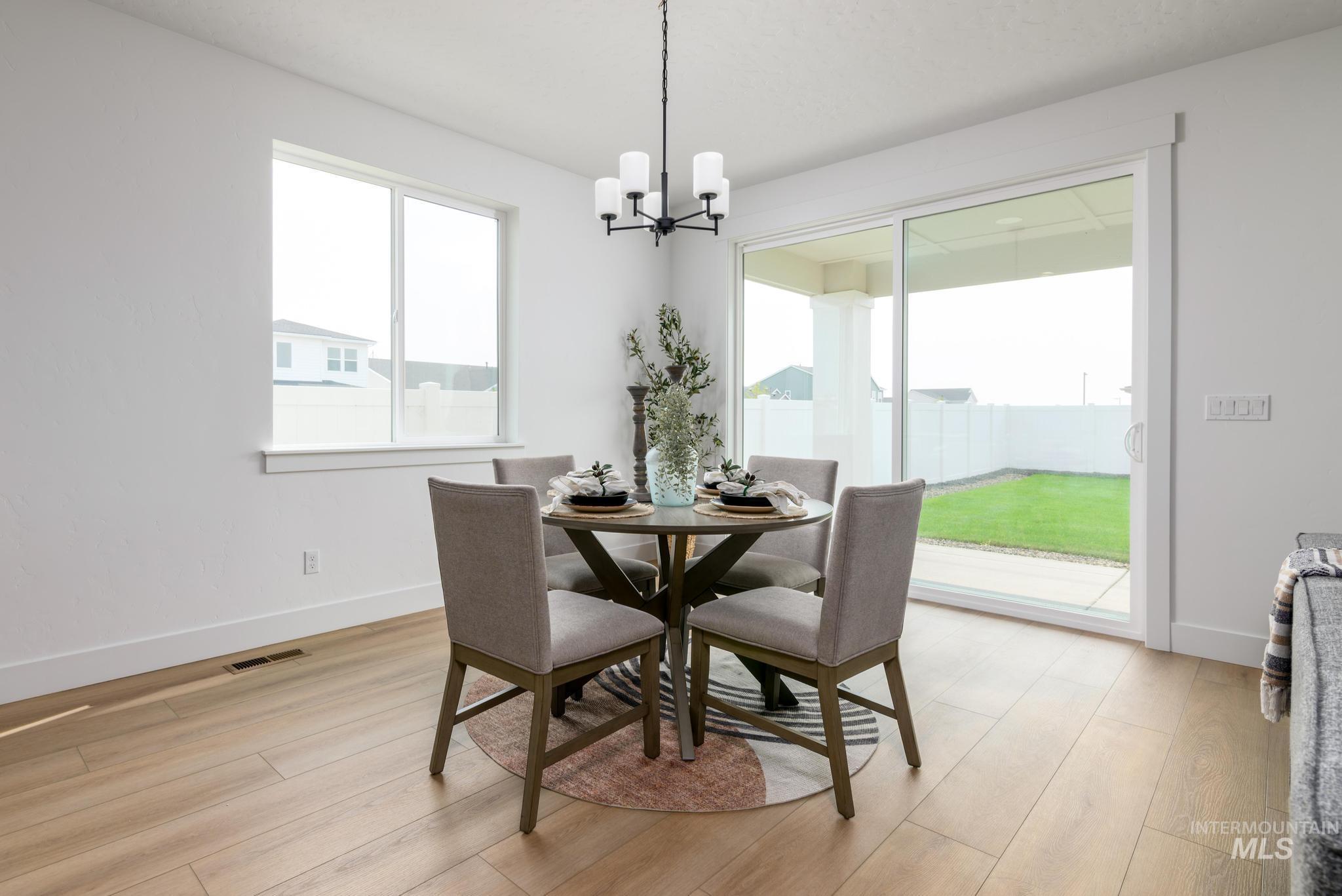 Dining area featuring hanging lights and light wood-style flooring
