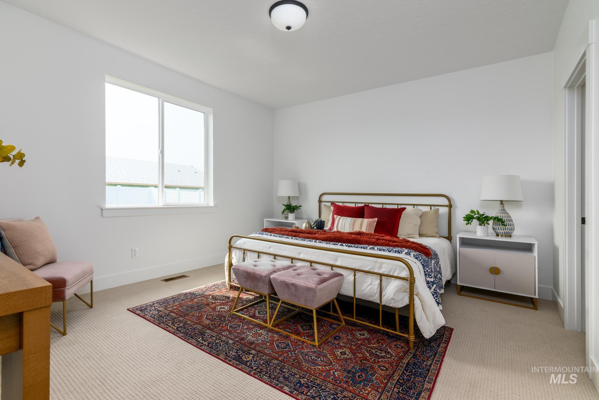 Bedroom featuring light carpet and baseboards