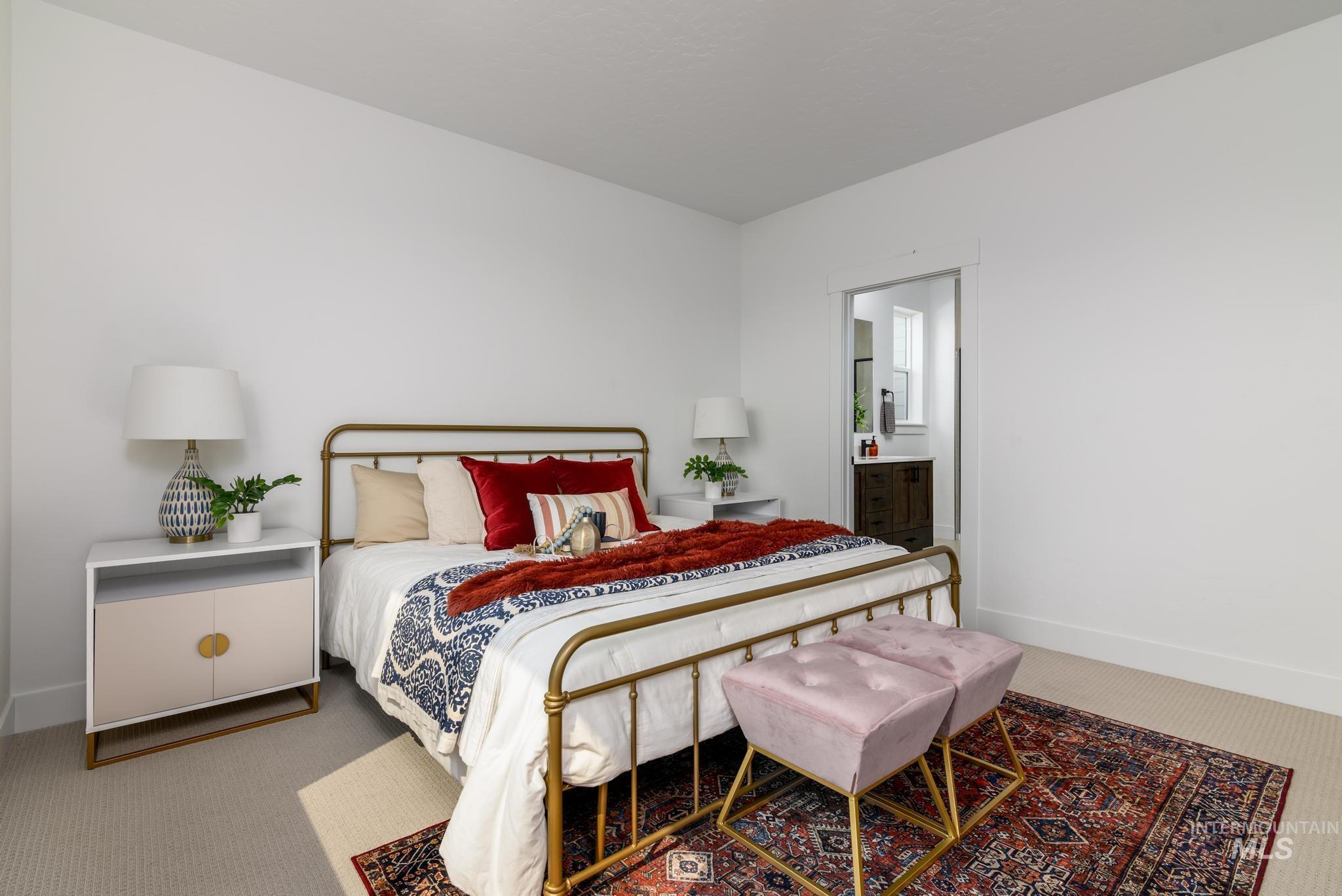 Bedroom with carpet floors and ensuite bathroom