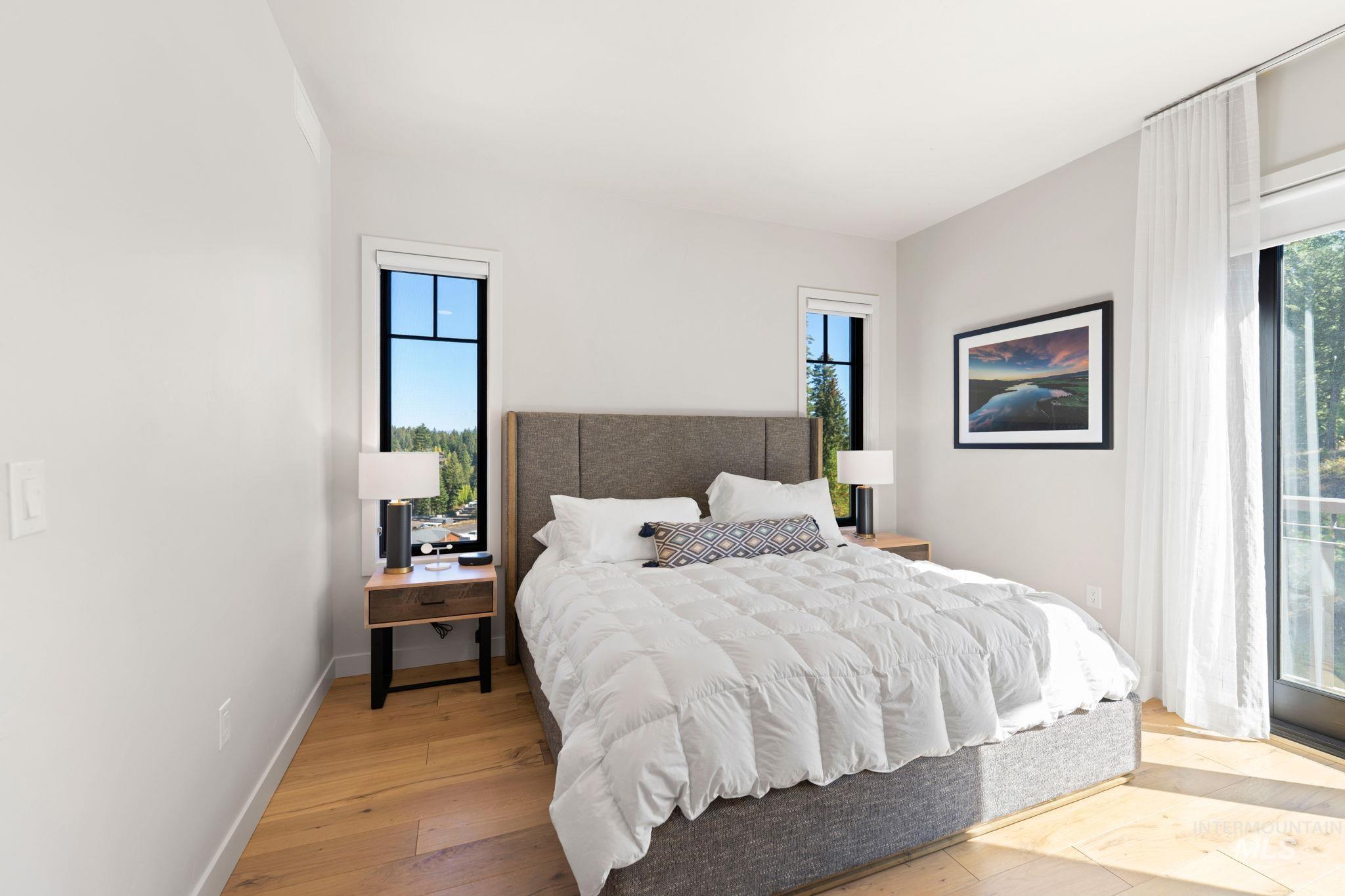 Bedroom featuring multiple windows and light wood-style flooring