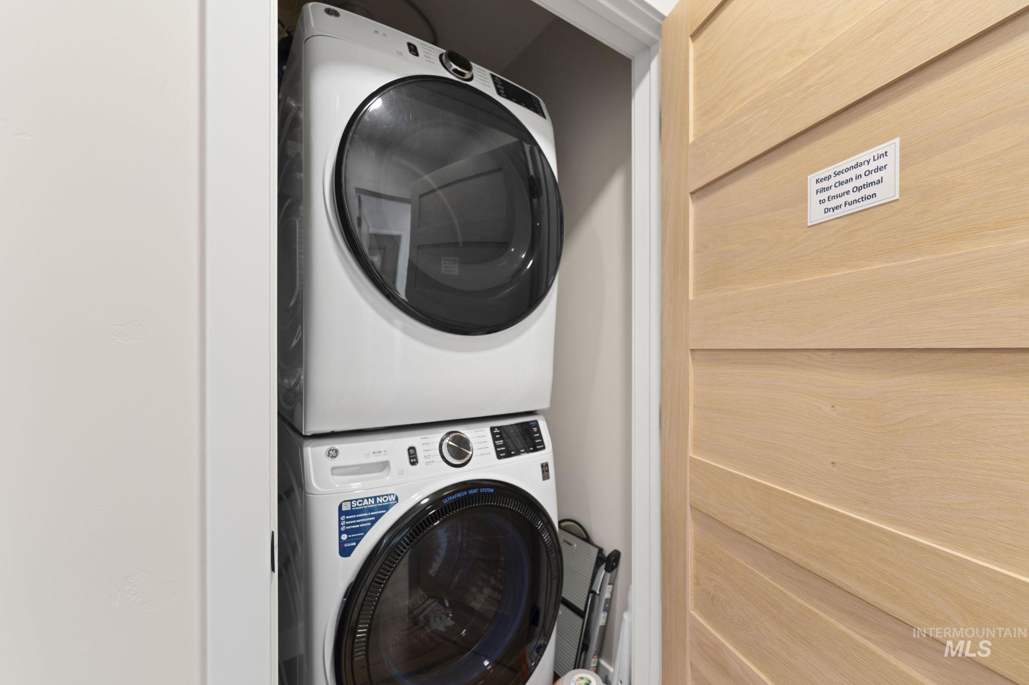 Washroom with stacked washing machine and dryer