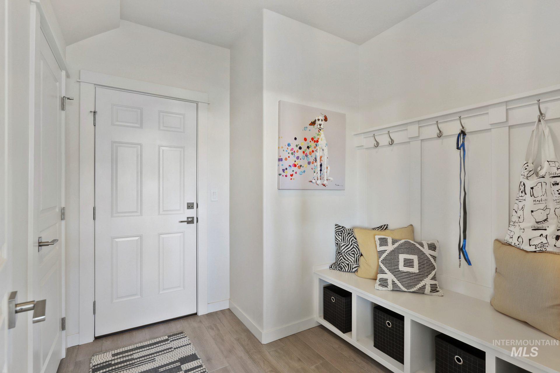 Mudroom with light wood-style floors and baseboards