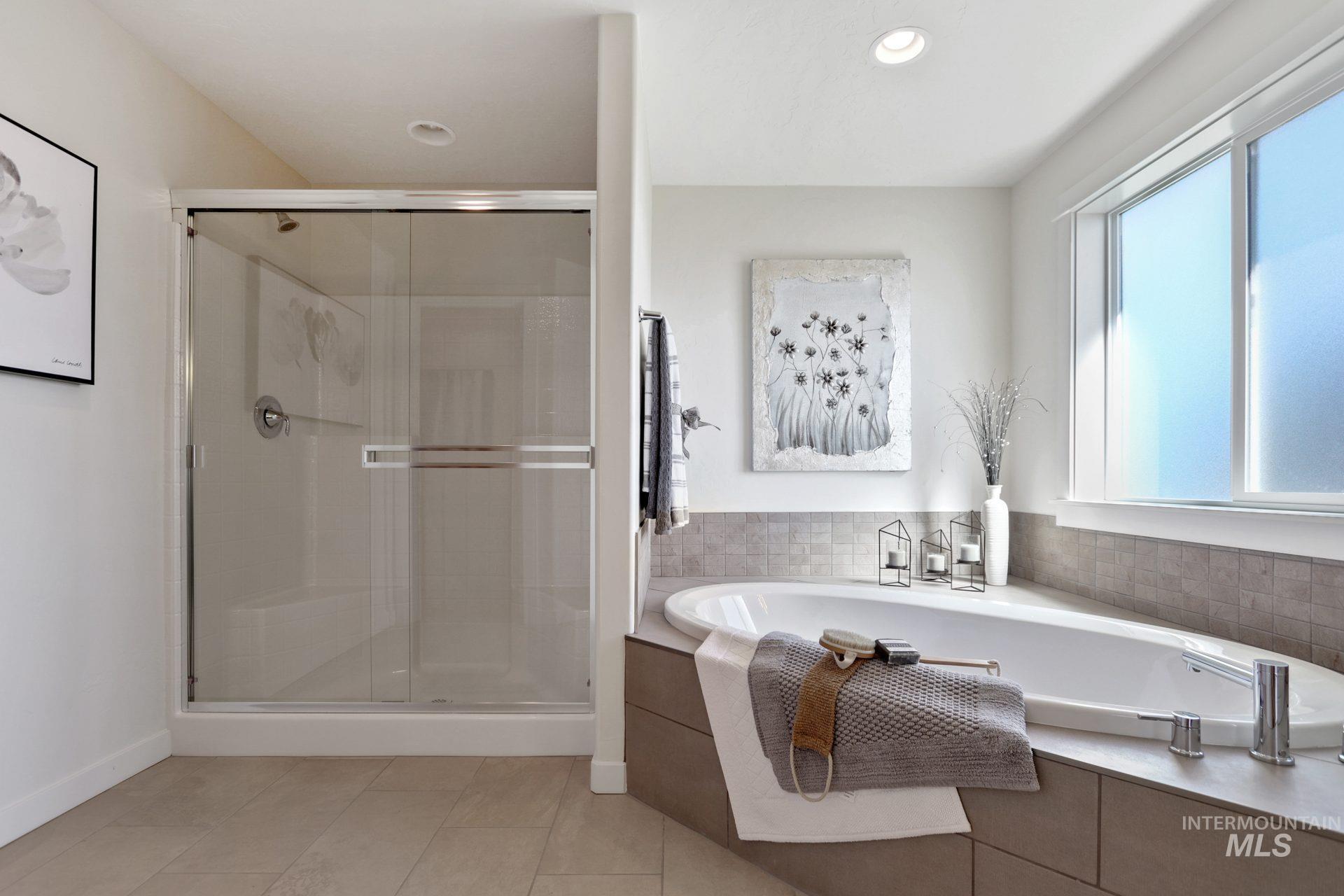 Full bath featuring a stall shower, a garden tub, light tile patterned floors, and recessed lighting