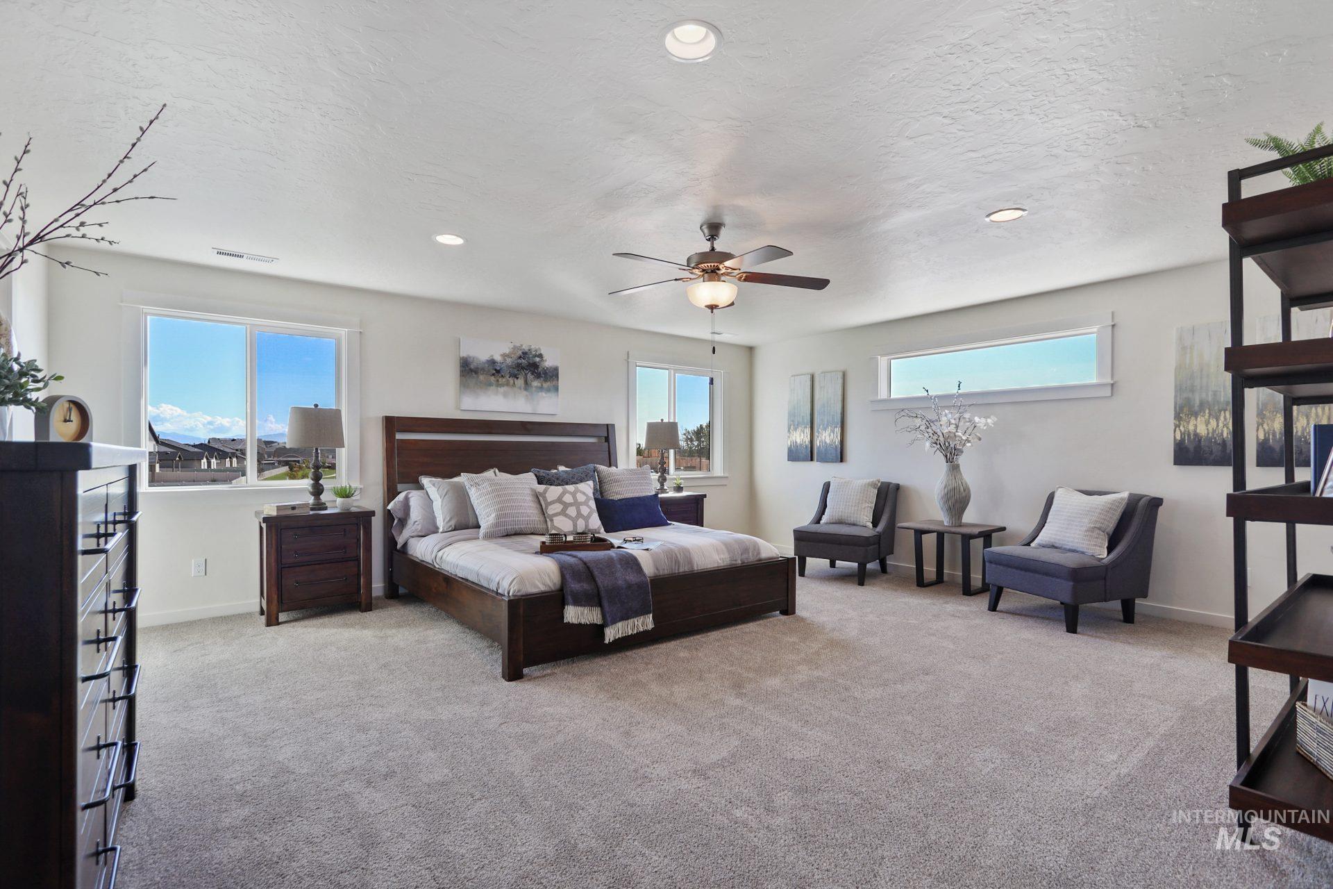 Bedroom with light carpet, a textured ceiling, recessed lighting, and a ceiling fan