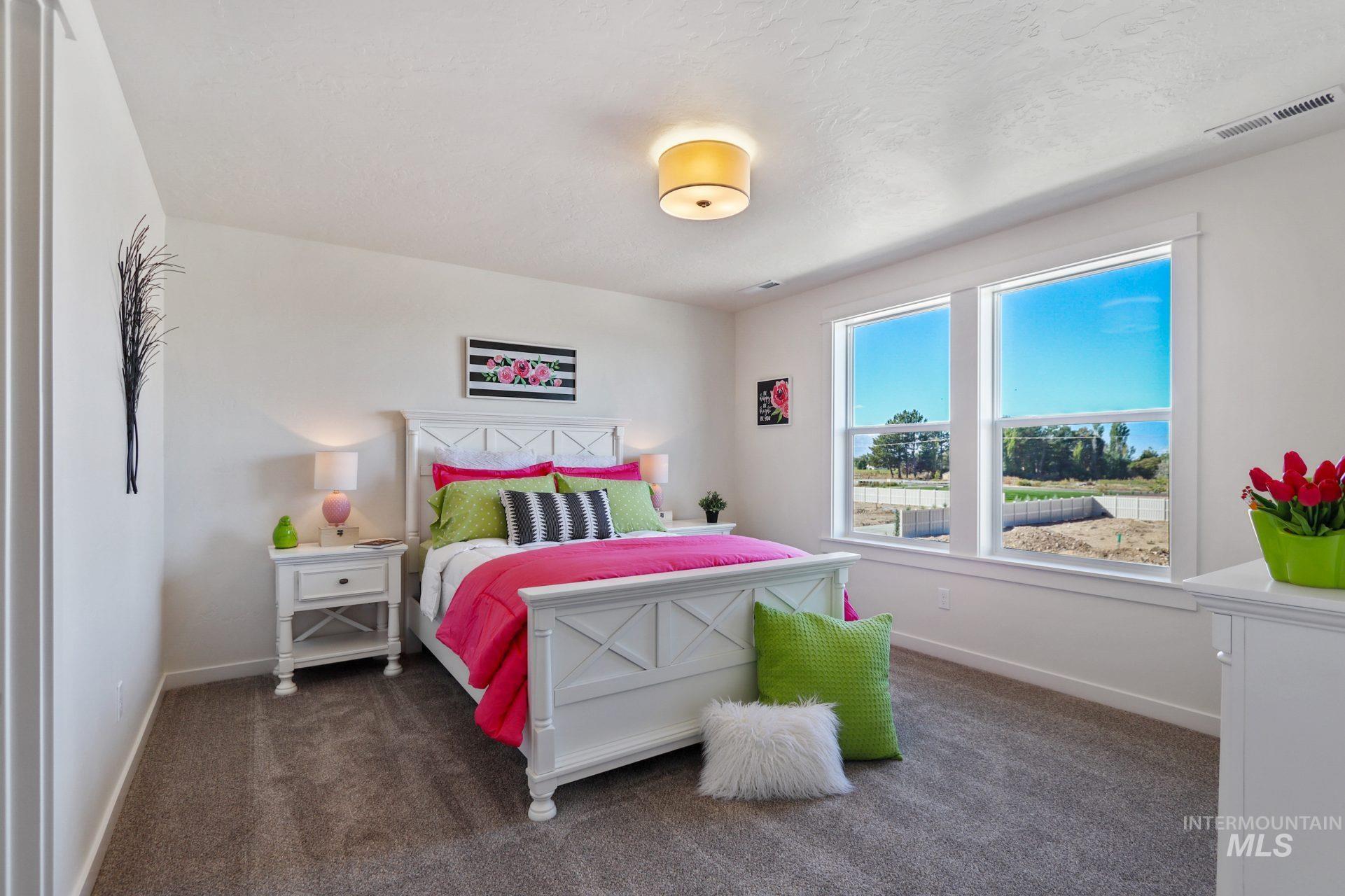 Bedroom with dark colored carpet