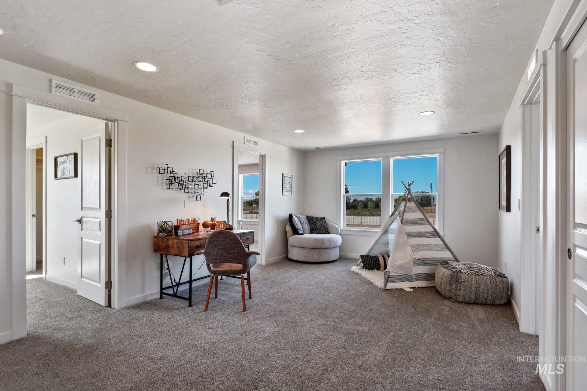 Playroom featuring carpet flooring, a textured ceiling, and recessed lighting