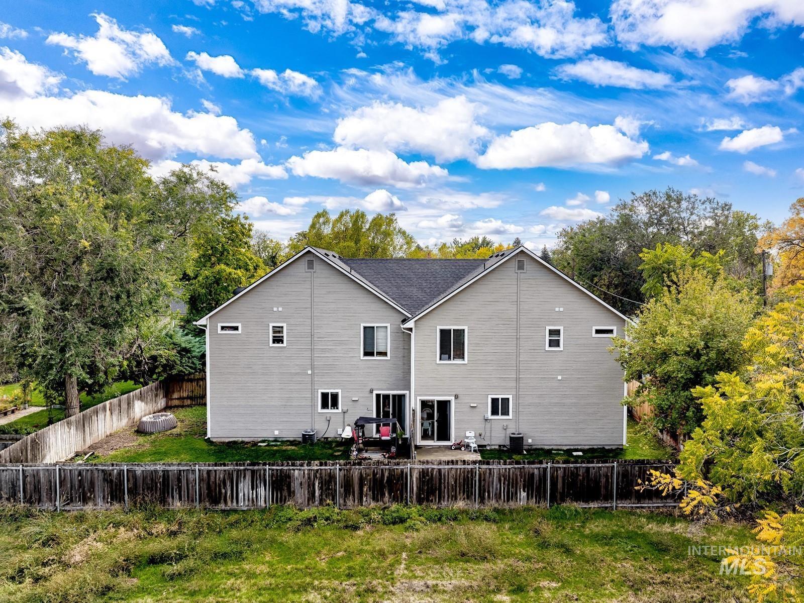 Rear view of house with a patio area and a fenced backyard