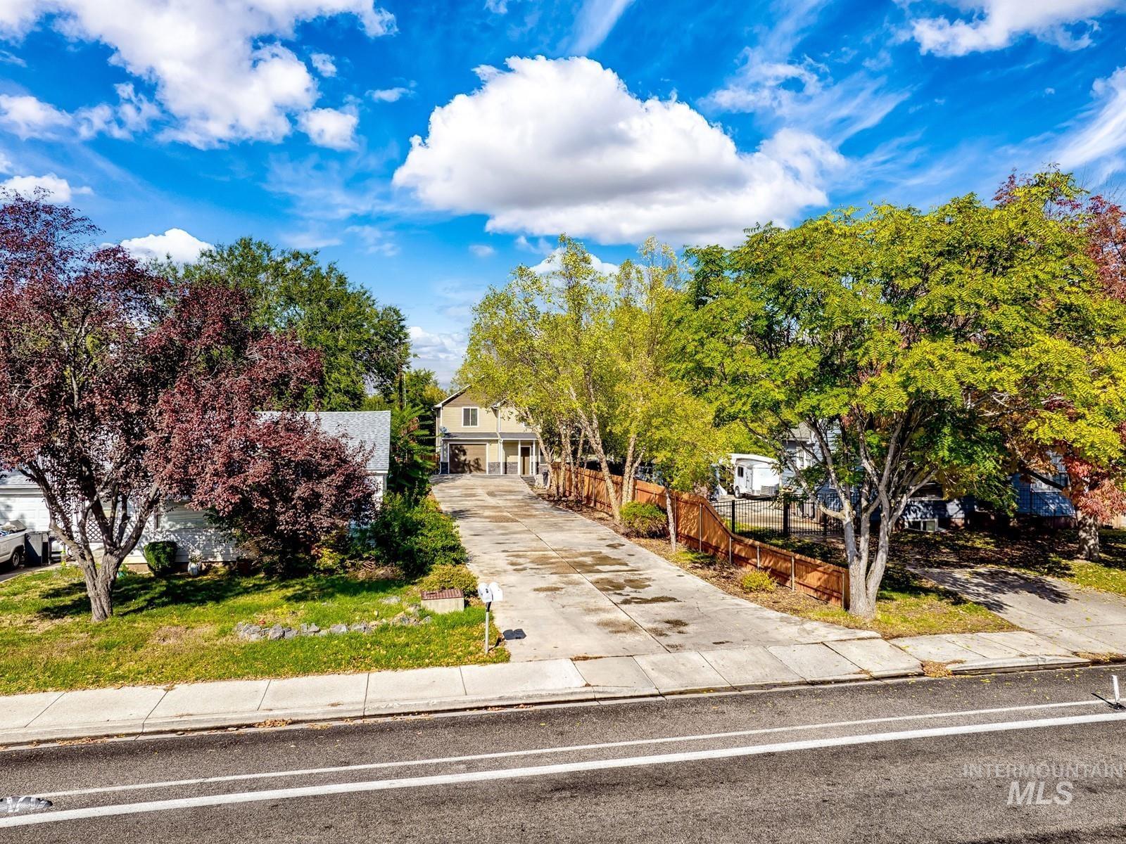 Obstructed view of property with driveway