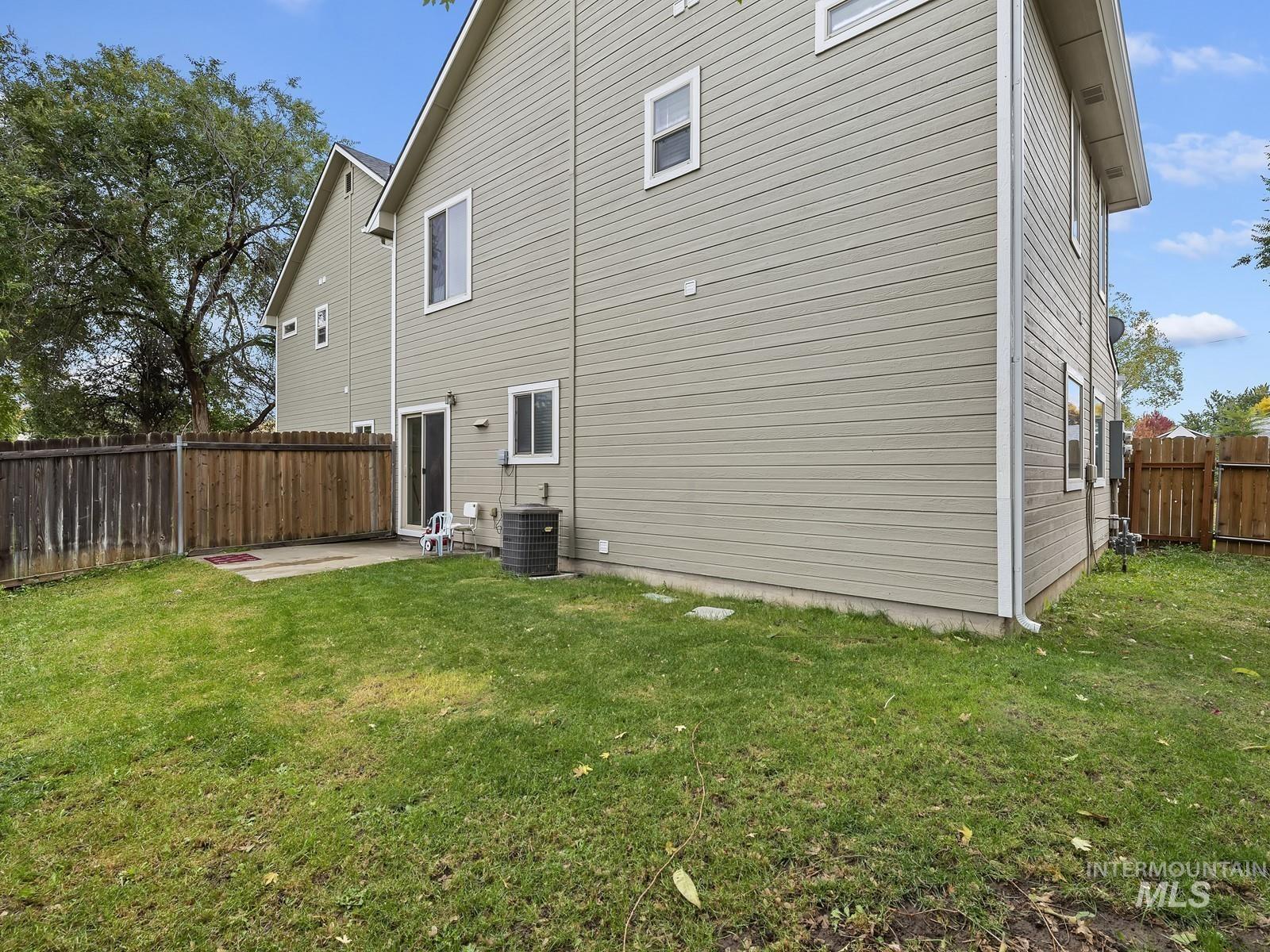 View of side of home featuring a fenced backyard and a patio area