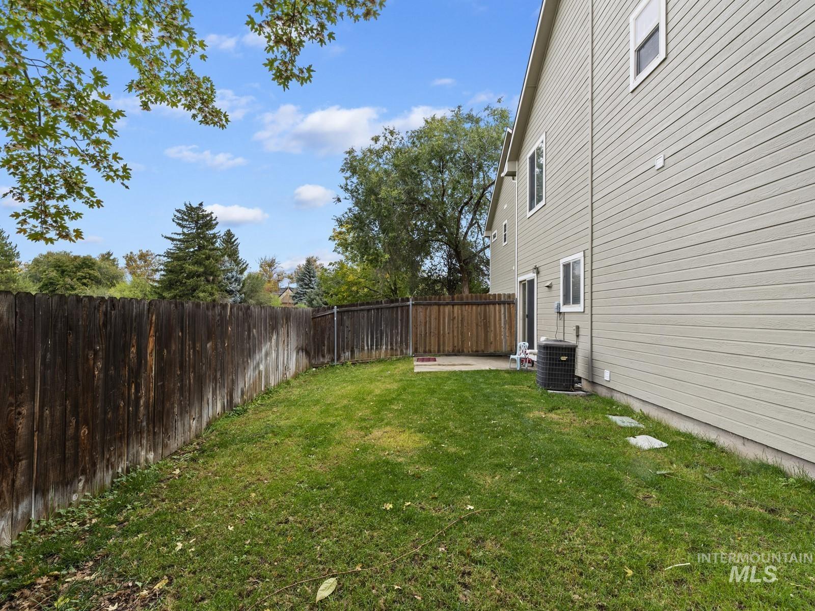 Fenced backyard with a patio