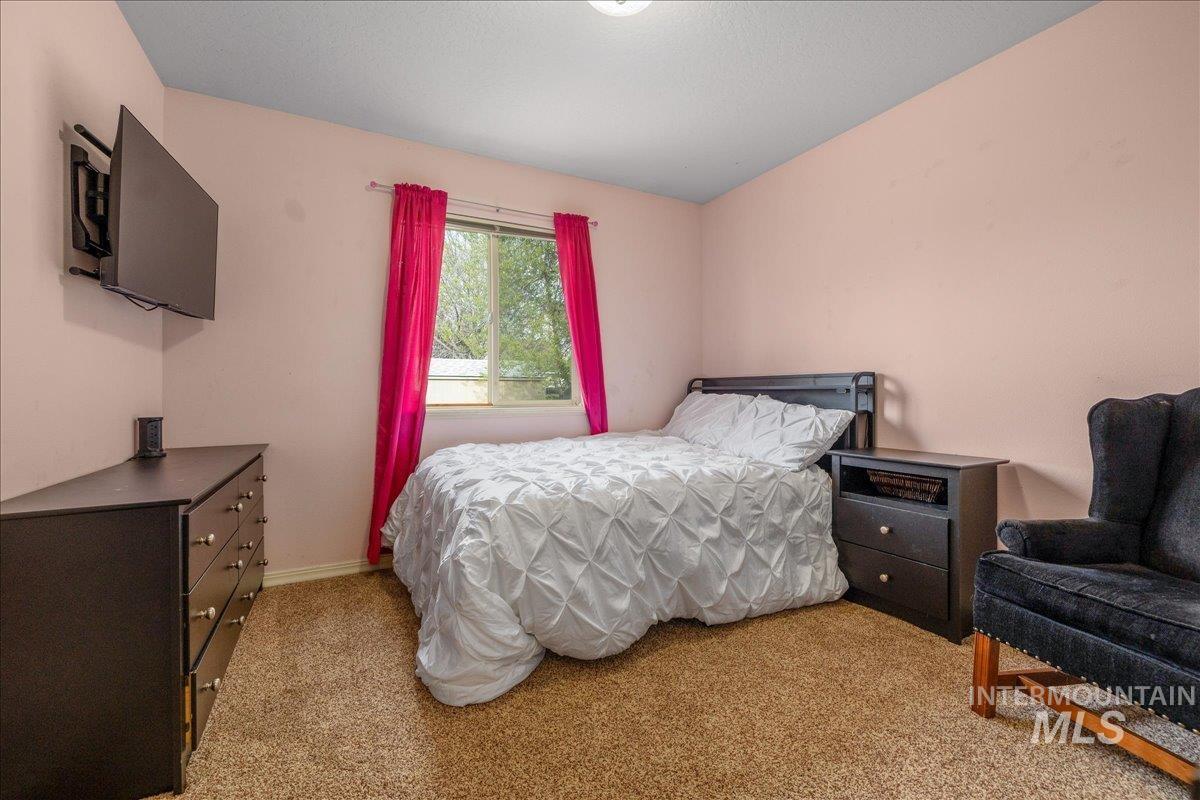 Bedroom featuring light colored carpet
