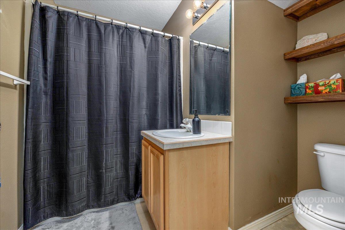 Full bathroom featuring vanity and curtained shower