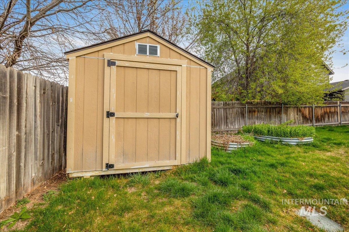 View of shed featuring a fenced backyard