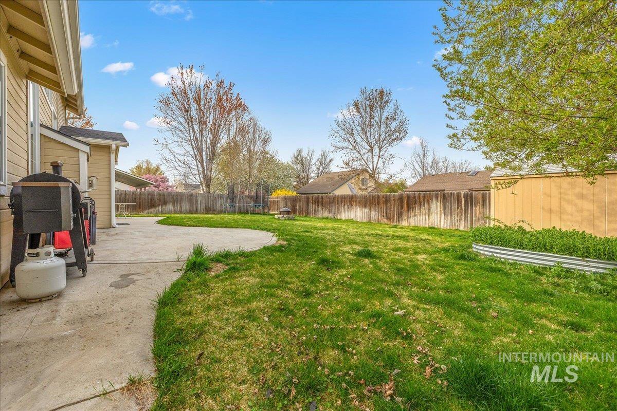 Fenced backyard featuring a patio