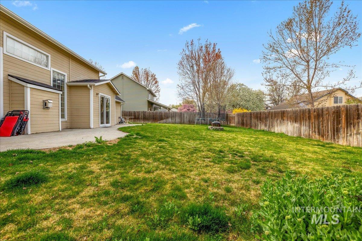 Fenced backyard featuring a patio