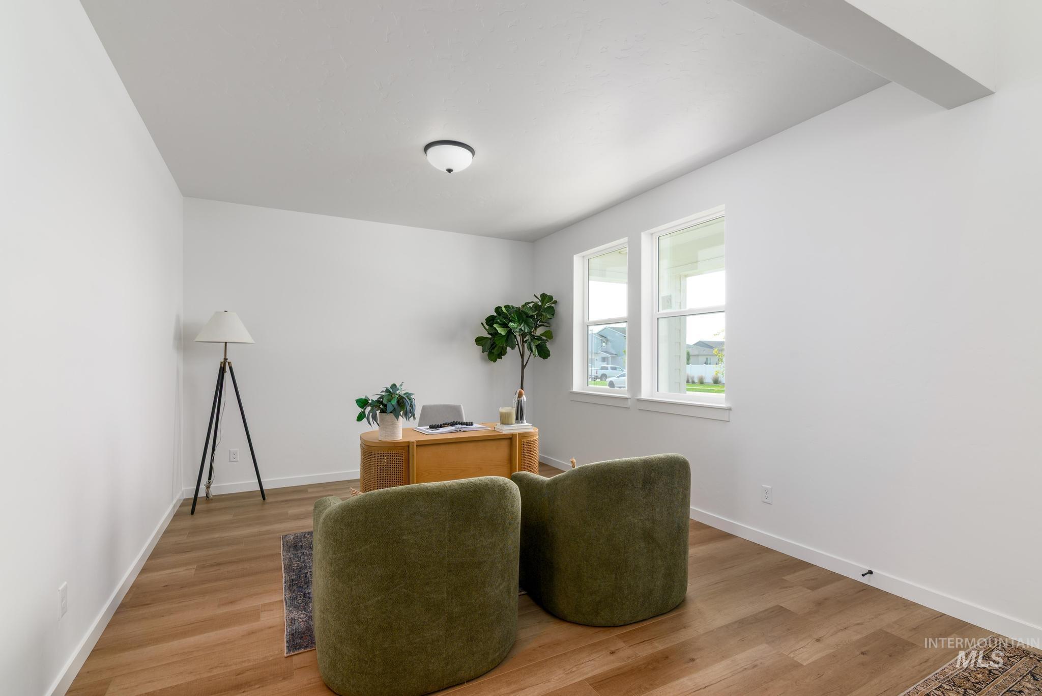 Office area featuring light wood-style flooring and baseboards