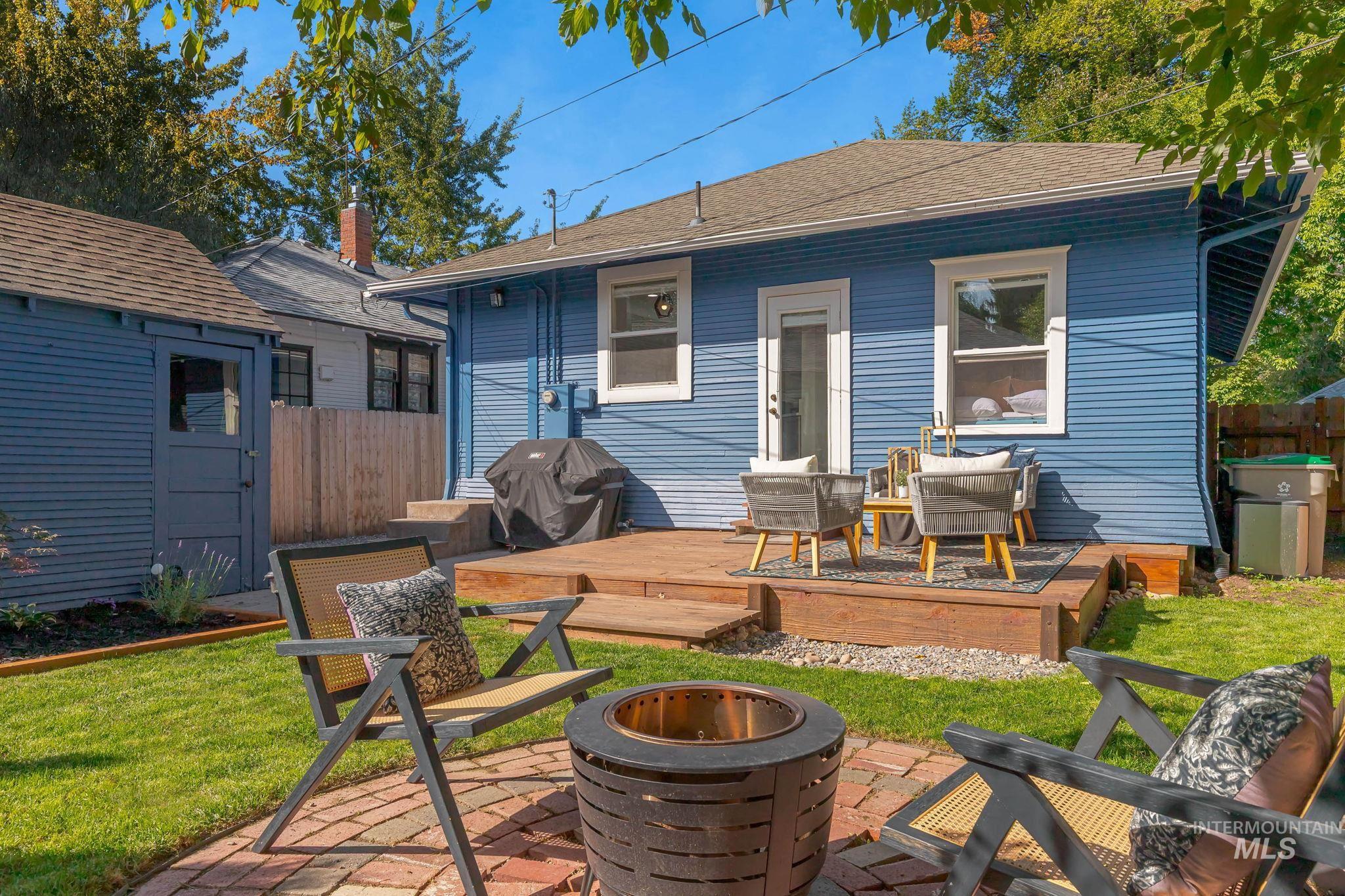 Rear view of property featuring a shingled roof and a deck