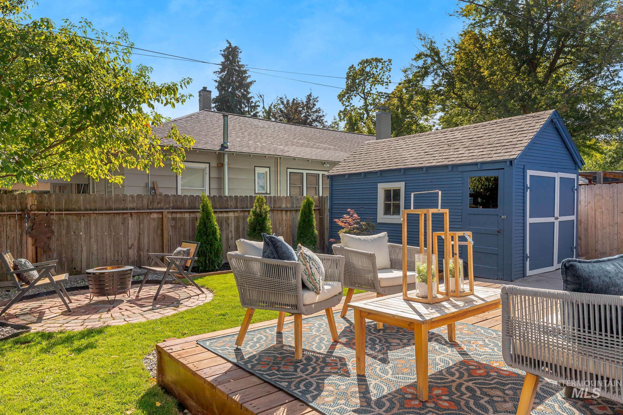 View of patio / terrace with an outbuilding and an outdoor living space with a fire pit