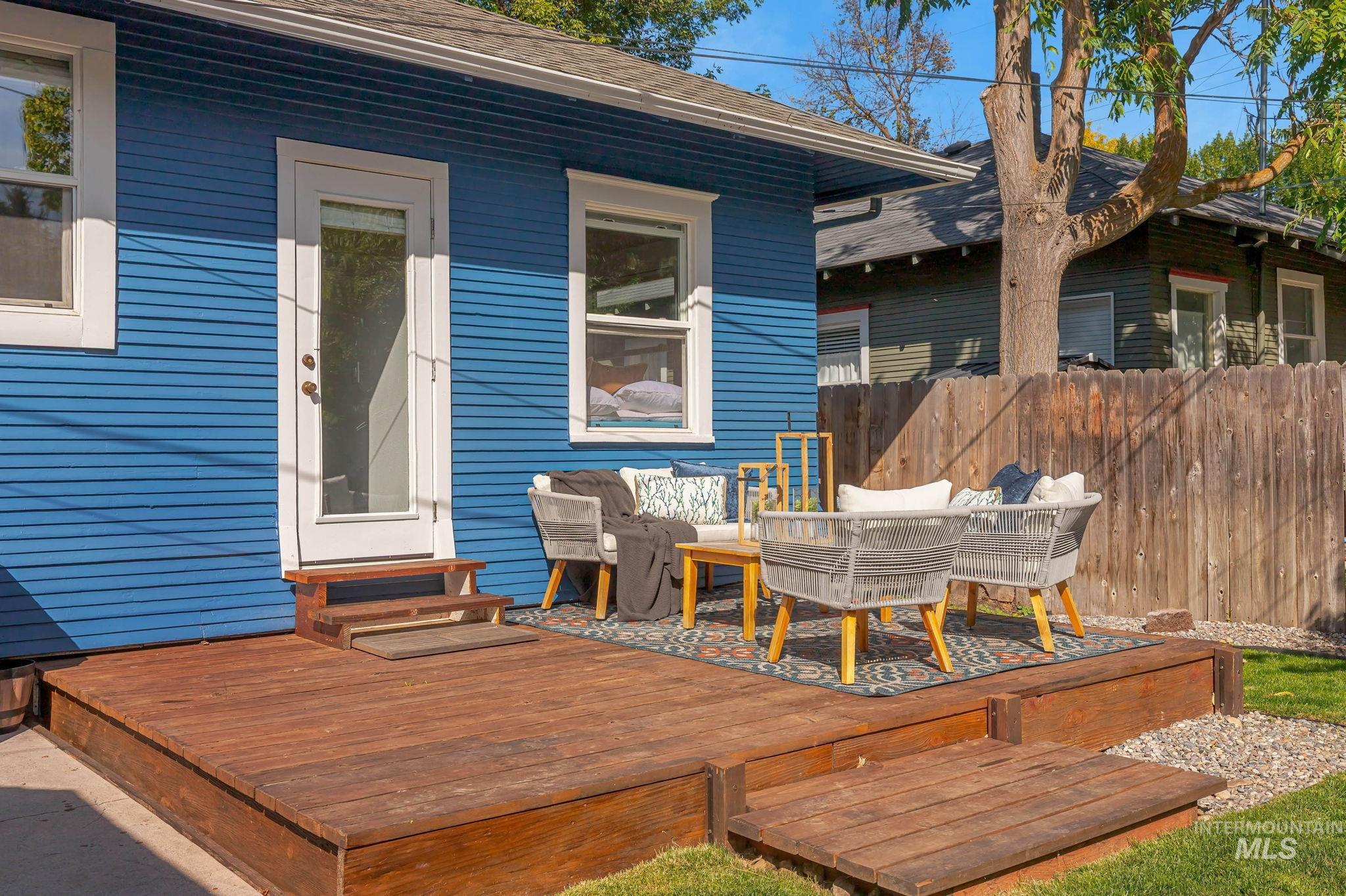 Deck with an outdoor hangout area and entry steps
