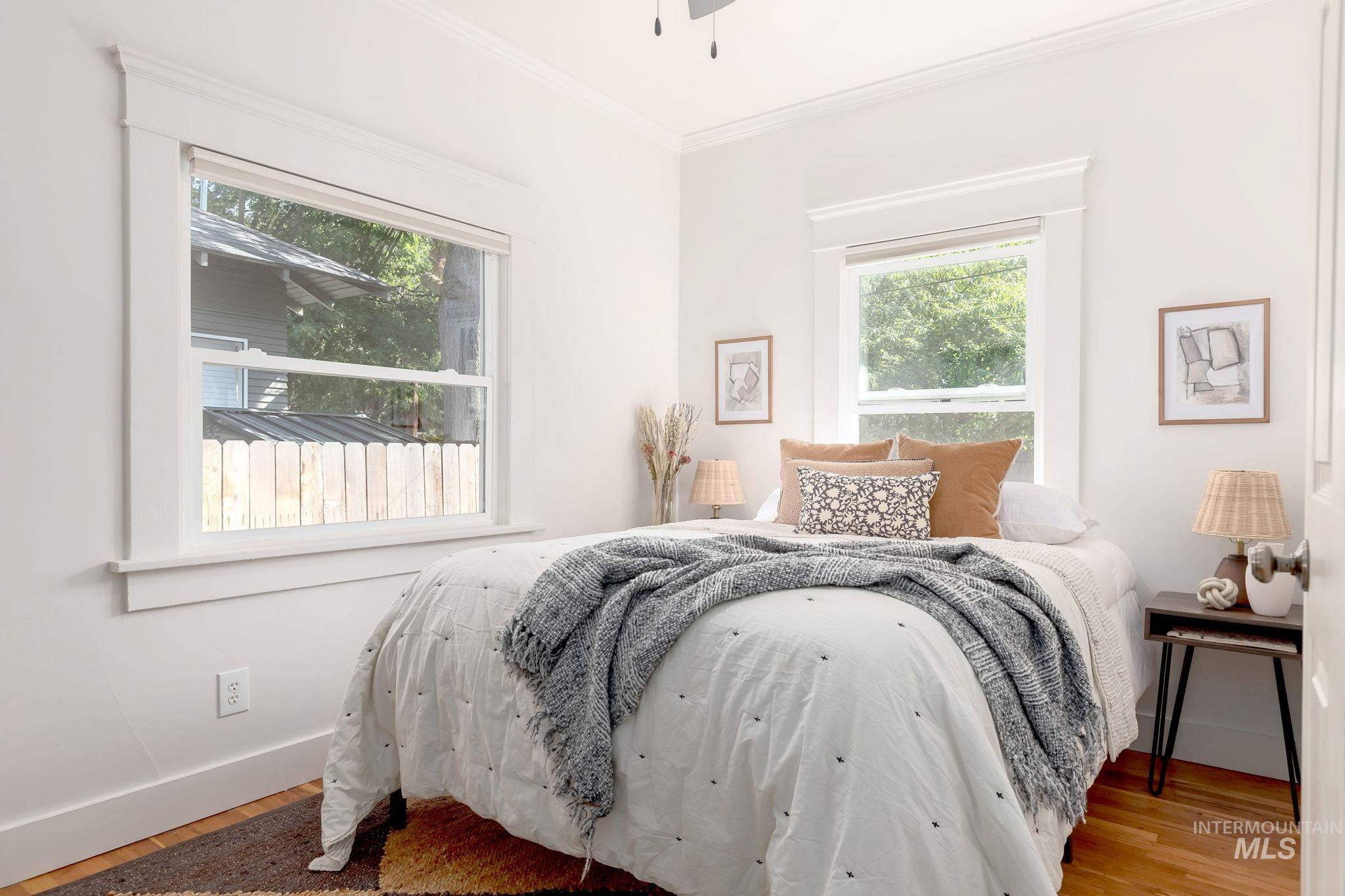 Bedroom featuring crown molding and wood finished floors