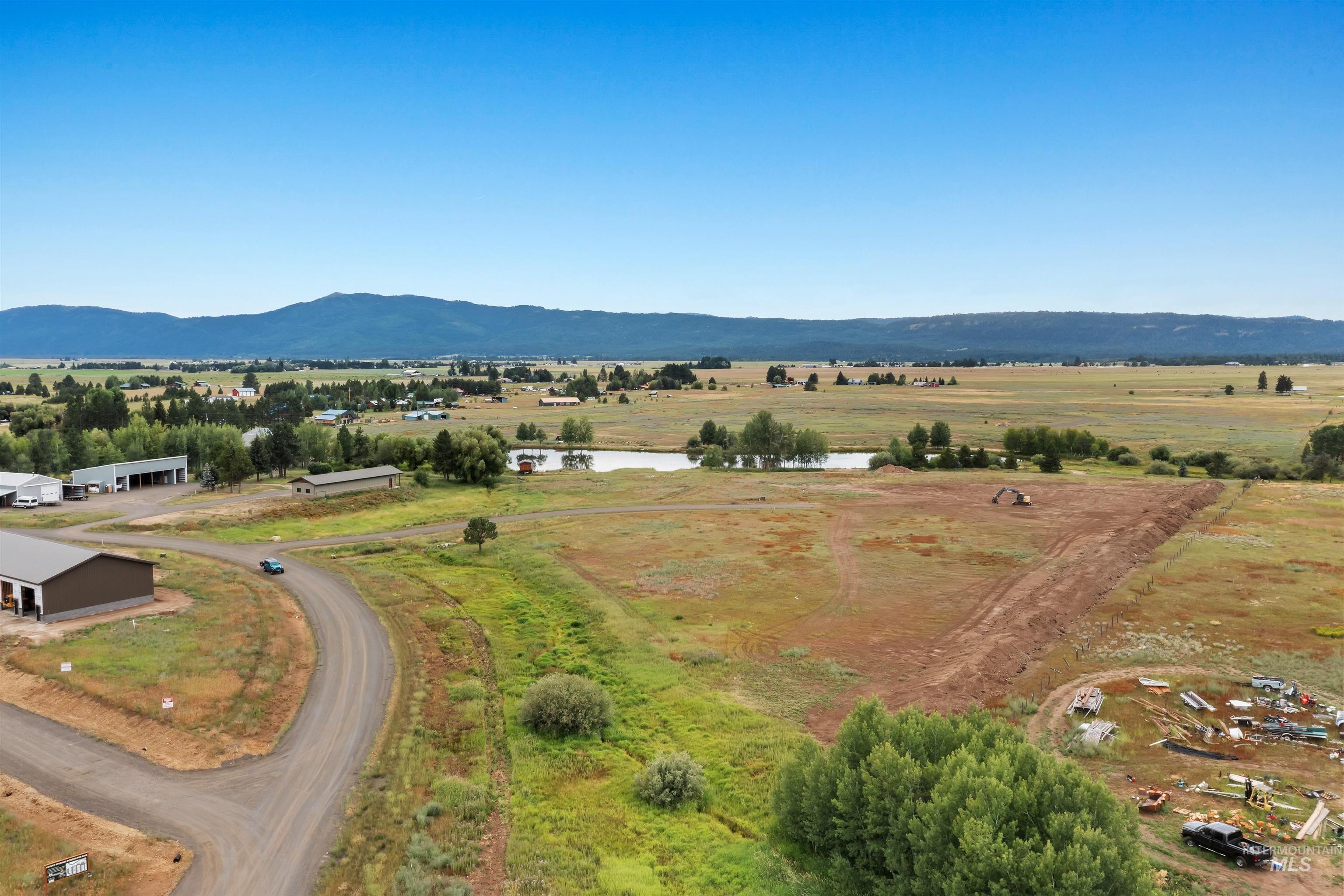 Aerial view of property's location featuring rural landscape and a water and mountain view