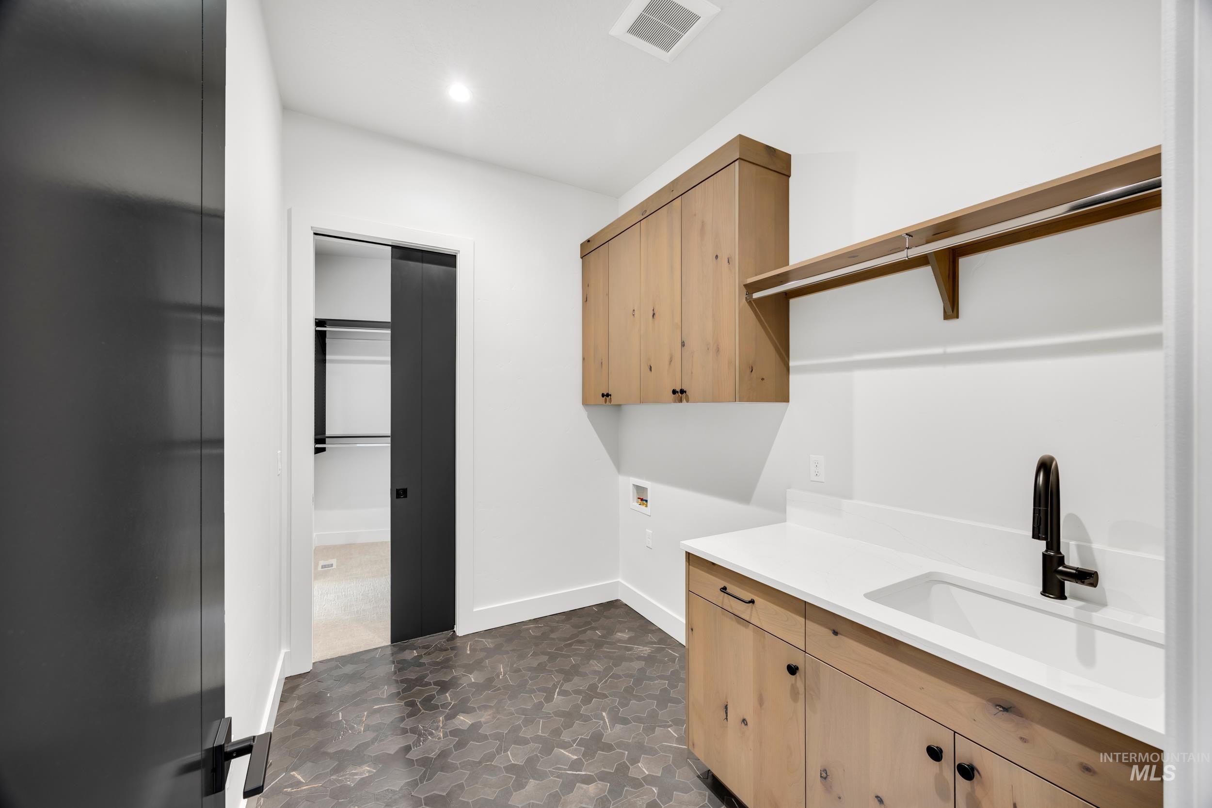 Laundry room featuring hookup for a washing machine and cabinet space