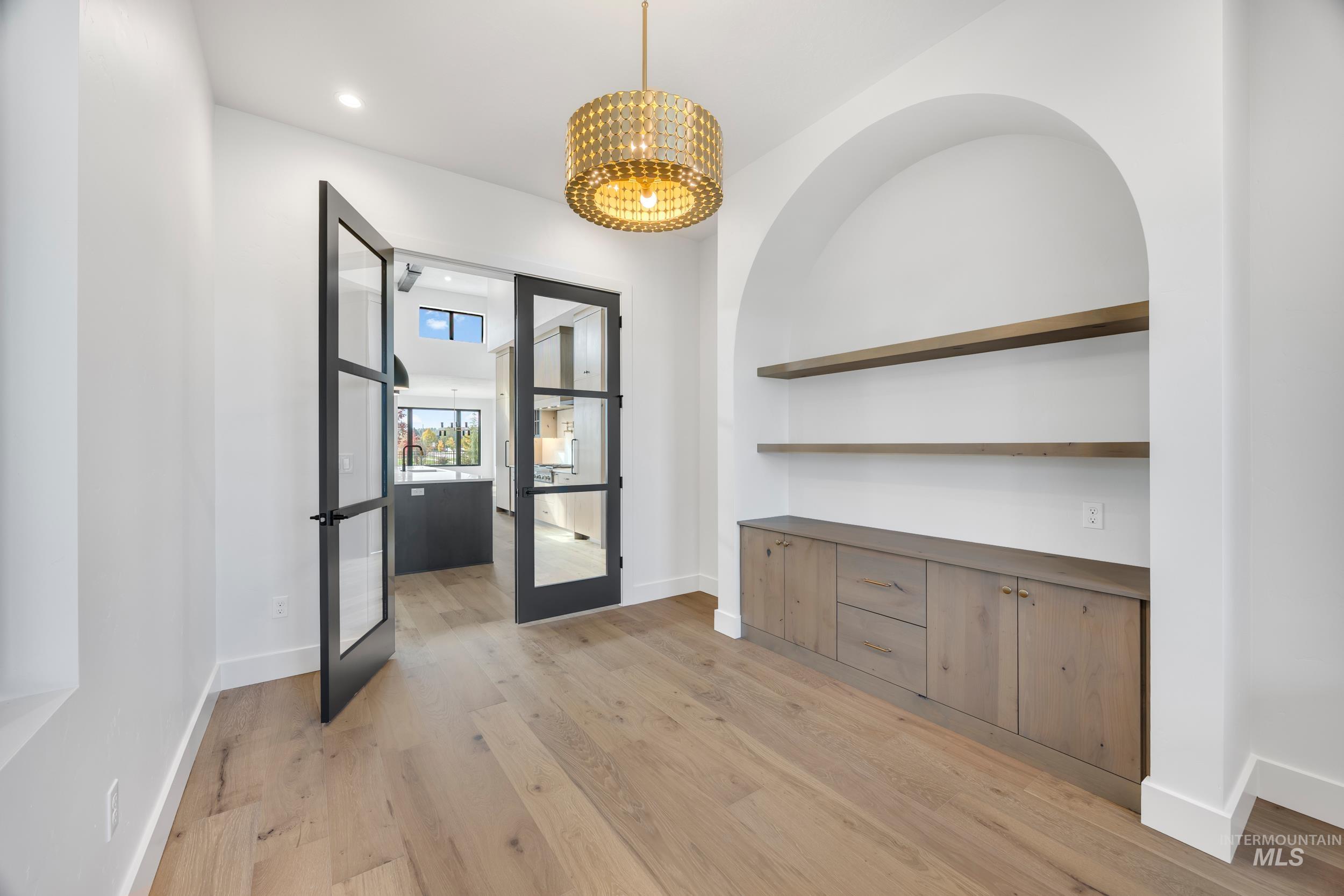 Unfurnished dining area with light wood-style flooring, french doors, and recessed lighting